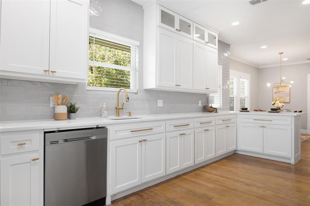 New Price + Motivated Sellers! Welcome to this beautifully updated Craftsman home in the heart of Dallas, just minutes from the vibrant Bishop Arts District, Downtown Dallas, and Lake Cliff Park. Blending historic charm with modern updates, this move-in ready home offers the character buyers love with the comfort and style today’s lifestyle demands. From the oversized covered front porch to the original hardwood floors, this home is full of warmth and personality. Natural light fills the open living spaces, while the modern fireplace creates a cozy focal point for relaxing or entertaining. The updated kitchen features stainless steel appliances, contemporary cabinetry, sleek countertops, and an open layout that flows seamlessly into the dining and second living area. The flexible floor plan includes three spacious bedrooms perfect for guests, a home office, gym, or creative studio. The primary suite offers a spa-inspired bathroom with dual sinks, frameless glass shower, and rainfall shower head. Updated secondary bathrooms feature clean, timeless finishes. Step outside to a huge fenced backyard with endless possibilities for entertaining, pets, gardening, or future expansion. Major system upgrades have already been completed, offering peace of mind and true move-in ready convenience. Located near Bishop Arts restaurants, coffee shops, boutiques, and nightlife, plus easy access to Downtown Dallas, Trinity Groves, and major highways, this home delivers the ideal combination of walkability, charm, and modern living. If you’re searching for a renovated Craftsman in Dallas with character, style, and an unbeatable location, this is the one.