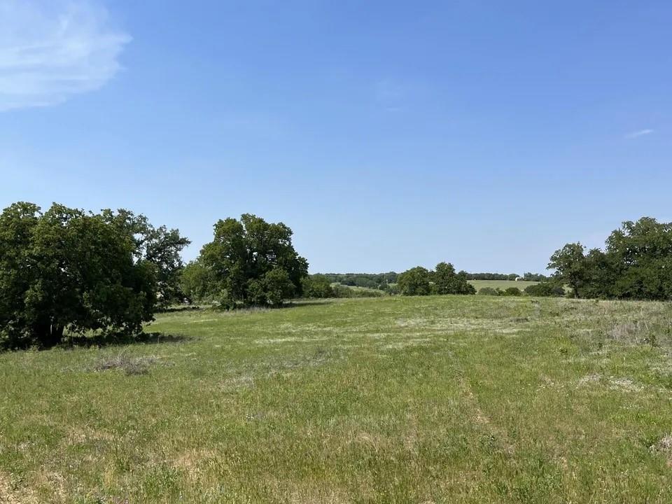 Lot 16 in Sarra Ranch, Parker County, Texas, offers a picturesque setting in the rolling hills. This ready-to-build 2-acre lot features a large open space, creating an ideal environment for constructing your dream home. The Sarra Ranch community spans 246 acres, consisting of 2 to 4 acre tracts. With a rich history of ranch life, this location is perfect for those seeking tranquil country living, surrounded by majestic oak trees. Residents can enjoy peaceful walks through the community or explore the area on horseback. Sarra Ranch is a deed-restricted community without an HOA, providing a unique blend of community guidelines and individual freedom for homeowners. Choosing Sarra Ranch means investing not just in a home, but in a lifestyle rich in country charm and lasting friendships. Lot 16 offers a more open space, allowing for flexibility and creativity in designing your home. The lot runs in a North-South direction, offering a favorable orientation for natural light and scenic views.