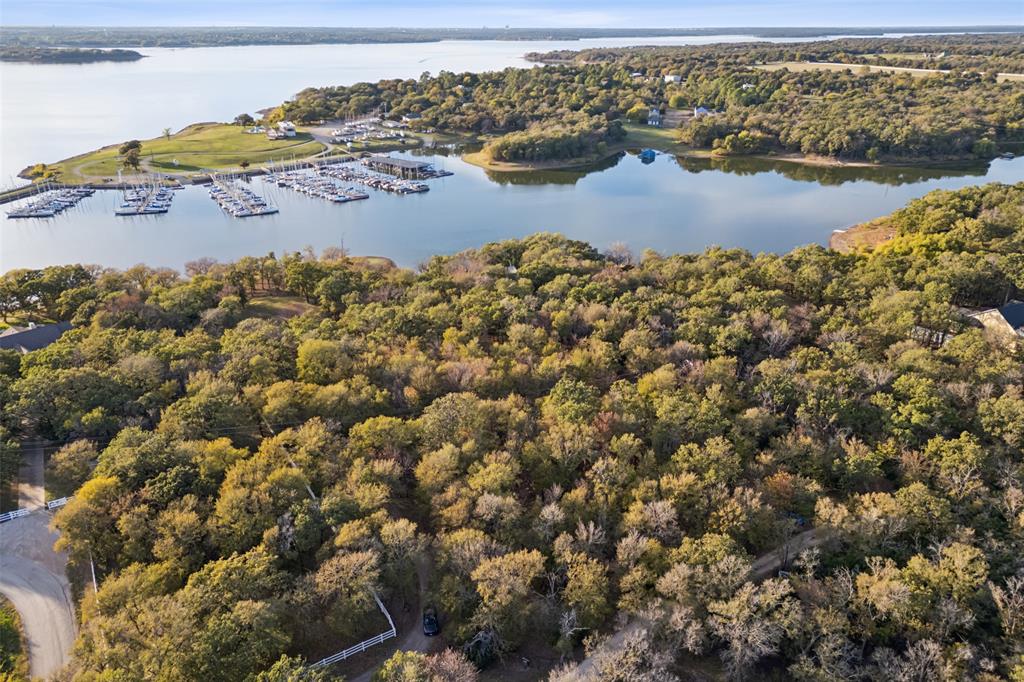 Welcome to 350 West Dickson Lane, a unique opportunity nestled in the heart of Oak Point, TX. This property offers two adjacent parcels (R156580 and R156581) offering dual elevated homesites with breathtaking views and over 400 feet of deep-water shoreline, making it a rare find for those seeking a serene waterfront lifestyle near the Dallas Corinthian Yacht Club.
Located in the City of Oak Point, this property benefits from favorable and flexible zoning (R3x), allowing for modern architectural designs with flat roofs and rooftop decks. Whether you're envisioning a contemporary masterpiece or a tranquil retreat, this site is cleared and ready for your vision.
Utilities are already in place with water, electricity, and septic onsite, ensuring a smooth transition from concept to creation. The location is both convenient and central, with just a 30-minute drive to Love Field, downtown Dallas, and DFW Airport, making it perfect for those who desire accessibility without sacrificing tranquility.
Oak Point is a growing and desirable area, surrounded by numerous new upscale subdivisions such as Gates at Water's Edge, Arbor Cove, and the newest Sanctuary Point. This vibrant community offers a blend of modern living and natural beauty, making it an ideal place to call home.
Don't miss the chance to be part of this thriving community and create your dream home on this exceptional property.