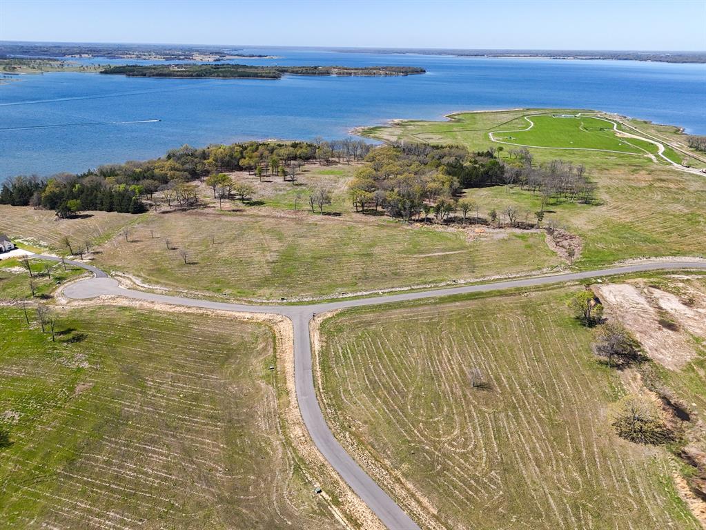 Listing Price is BELOW the seller's acquisition price! Build your dream lakefront home at 330 Lakewood Lane in The Shores at Peninsula on the new Bois d'Arc Lake! Take a scenic evening walk down to the lake and enjoy the sunset as you look to the west.  Discover community activites like pickle ball courts, dog walk, and entertaining friends and family at the existing multi-million dollar clubhouse.  There is a putt-putt course and an infinity pool for endless fun and relaxation.  This is a gated community with all the exceptional standards you would come to expect from this nationally recognized developer. The current development rules allow for short term rentals with some light restrictions. Choose your own builder and build on your timeline! The excitement of the new Bois d'Arc Lake is increasing daily! Come see this one of a kind lot today!!