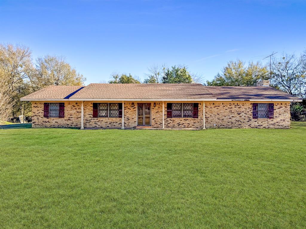 Discover the possibilities with this 4-bedroom, 2-bath home situated on 17.64 acres perfect for privacy, recreation, or agricultural. Located right outside peaceful Kerens, Texas, this property offers room to spread out and make it your own. Inside, you’ll find a spacious layout featuring a large living room with a wood-burning fireplace, a formal dining room with its own wood-burning stove, and a generously sized laundry room equipped with abundant shelving for storage. The bedroom off the front entrance is ideal for a home office, study, or guest room. All bedrooms include walk-in closets, and the main bathroom is equipped with a handicap-accessible tub. Step outside to enjoy the covered back patio, perfect for outdoor relaxation or shaded parking. The backyard includes an old pool house offering even more space for tools, equipment, or hobbies. This property is a true fixer-upper, ready for someone with vision to bring new life to its great bones and impressive acreage. With its combination of space, character, and potential, this Kerens gem is a rare opportunity you won’t want to miss!