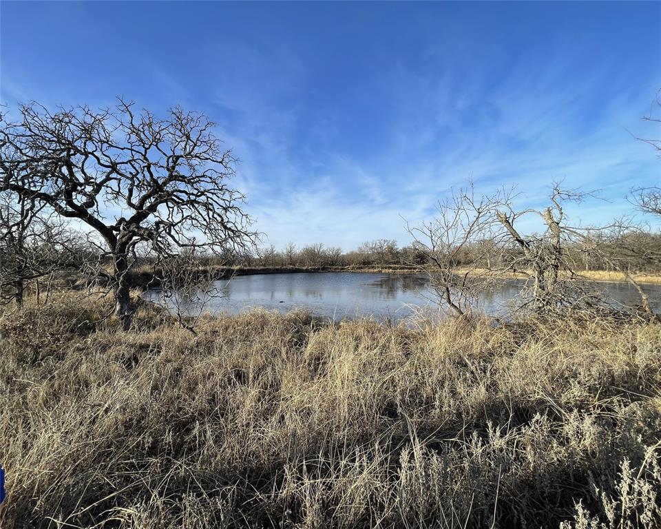 228± acres of wide-open Texas land just outside of Jacksboro, where the possibilities are as big as the sky. Tucked behind a county-maintained gate for added privacy and security, this ranch is the kind of property people dream about when they want room to breathe, explore, hunt, fish, ride, or simply get away from the noise of everyday life. Located approximately 5 miles from town, you still have easy access to restaurants, groceries, hardware stores, and other small-town conveniences while enjoying the peace and freedom of country living.
The landscape offers rolling pasture, mature hardwoods, native grasses, and excellent cover for wildlife. Whether your plans include cattle, horses, hunting, or recreation, this property is well-suited for it all. Three ponds provide water for livestock and wildlife and also offer great fishing opportunities. Wildlife is abundant with whitetail deer, wild hogs, turkey, quail, and dove frequently seen throughout the property.
This ranch is especially ideal for recreation. Bring the ATVs, 4-wheelers, dirt bikes, or side-by-sides and let the adventures begin. Spend weekends exploring trails, casting a line at the pond, hunting at sunrise, or gathering around a fire under a sky full of stars. The sunrises and sunsets out here are something special.
The property is fully fenced and previously held an agricultural exemption, which could likely be re-established with qualifying agricultural use. With no city restrictions, you have the flexibility to operate a working ranch, create the ultimate recreational retreat, or hold a legacy property to enjoy for generations to come.
