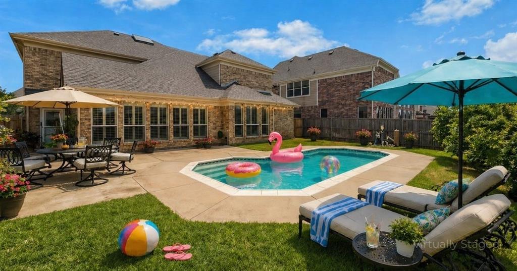POOL HOME near Joe Pool Lake with luxury upgrades, primary suite downstairs, and spacious layout perfect for entertaining! This stunning home features a grand spiral staircase with oil-rubbed bronze balusters, abundant natural light, and elegant finishes throughout. Open-concept living room and kitchen designed for gatherings, plus formal dining, formal living, and an office. High-end features include engineered hardwood floors, NEW carpet, extensive crown molding, decorative wall molding, and approximately $25K in custom wood plantation shutters. Swarovski crystal chandeliers add an elevated touch of elegance. Primary suite DOWNSTAIRS offers a private retreat with ensuite bath and beautiful views of the backyard POOL, lush landscaping, and producing fig and pomegranate trees. Enjoy outdoor living with a large backyard, green space, and room to relax or entertain. Upstairs includes 3 bedrooms, 2 full baths, GAME ROOM, and MEDIA ROOM—ideal for flexible living and entertainment. Additional upgrades include cedar insulated garage doors and epoxy garage floors and a NEW roof less than a year old. Located just minutes from Joe Pool Lake with easy access to Dallas and Fort Worth. This home combines LOCATION, LUXURY, and FUNCTIONALITY—don’t miss it!  Furniture can be purchased.