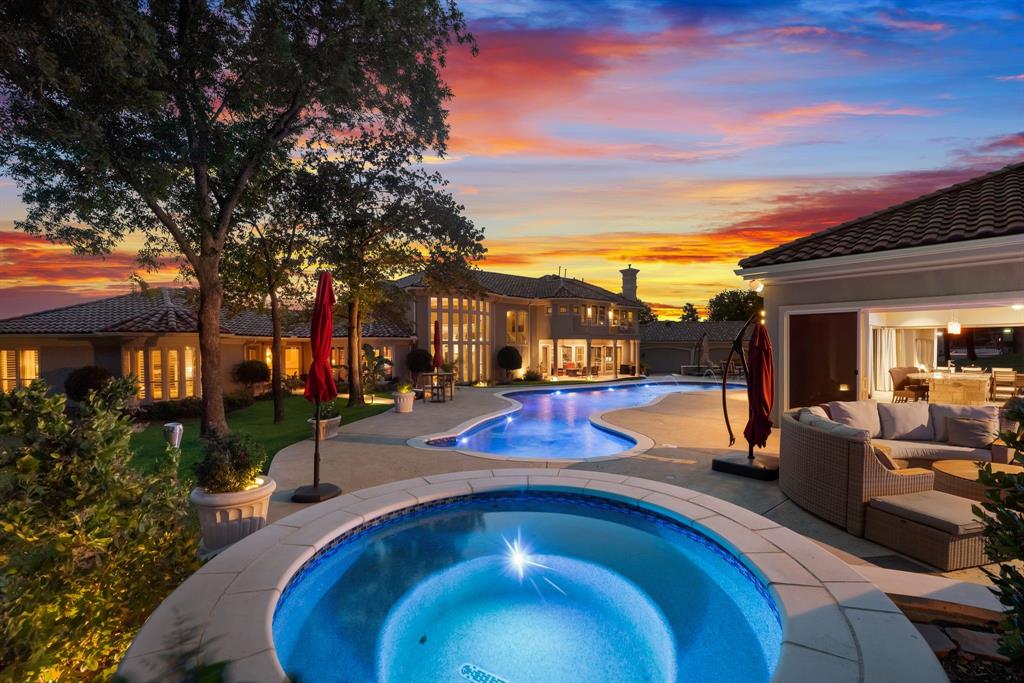 Magnificent Luxury Golf Course Estate with Exceptional Amenities! 
Stunning 4-bedroom, 5-bath sprawling home on a rare corner plus cul-de-sac 2 acre lot in the exclusive 24-7 guarded and gated community -  The Estates at Tour 18. Over 6,300 sq ft of refined living featuring soaring cathedral ceilings, wall of windows, glass stanchion grand staircase and smart home conveniences. Gourmet kitchen, temperature controlled wine room, handsome office, private exercise room, game room with kitchenette and balcony. The luxurious primary suite includes a double sided fireplace and private patio alcove sitting area - a lovely sanctuary for morning coffee. Gorgeous views from every window!

Dream backyard oasis captivates with resort-style meandering pool, spa, fire pit, freestanding chimney, luxury cabana with designer grill station, entertainment bar, ice maker, warming oven, dishwasher, half bath, and fridge - Entertainer's Dream! Spanish tile roof and gated motor court with 5 car garage complete the package. Abundant storage throughout. Minutes from award winning Argyle ISD, Liberty Christian, top shopping, fine dining, healthcare and both DFW & Love Field airports. WOW!