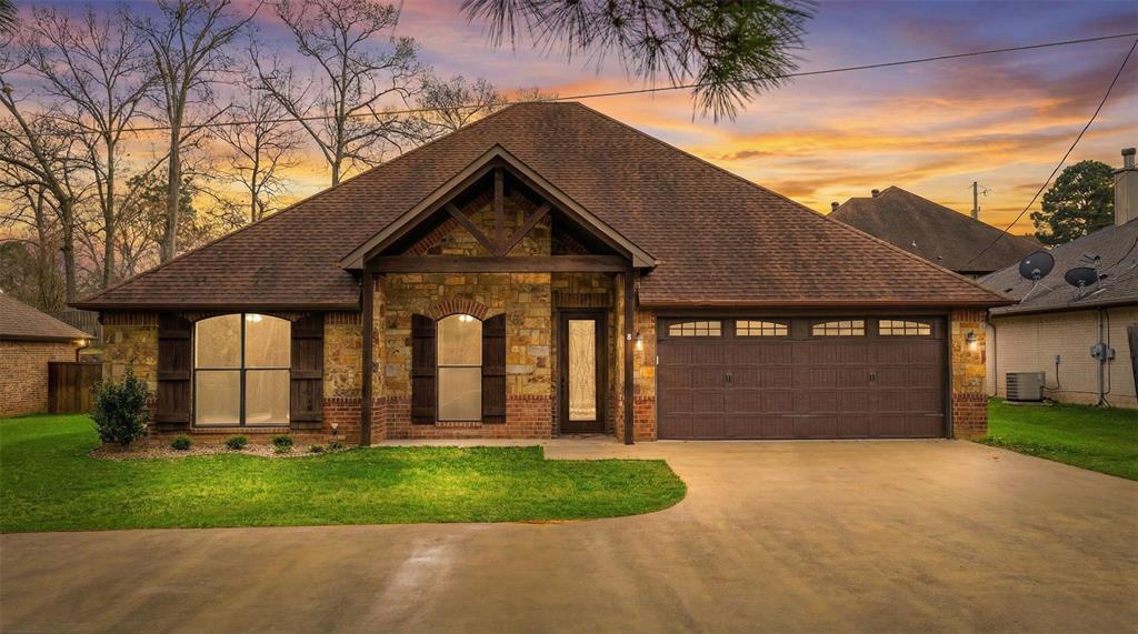 This beautiful 4-bedroom, 2.5-bath home offers 2,116 square feet of comfortable living space and is perfectly situated in highly sought-after Spring Hill Independent School District. Conveniently located right in the heart of town, you’ll enjoy easy access to shopping, dining, and SHISD schools. This well-kept traditional brick-and-stone home showcases excellent curb appeal with charming wood shutters, a welcoming covered entry, manicured landscaping, and a spacious two-car garage. Step inside to find gorgeous wood flooring, crown molding, recessed lighting, and a warm, inviting stone fireplace that immediately catches your eye in the spacious living area. Large windows bring in abundant natural light and offer peaceful backyard views. The thoughtfully designed split layout places the secondary bedrooms toward the front of the home, while the private primary suite is tucked just off the spacious living area for added comfort and privacy. The kitchen is conveniently positioned just off the living room, creating a natural flow for everyday living and entertaining. It features rich wood cabinetry, granite countertops, a stylish tile backsplash, stainless steel appliances, an island for additional prep space, and a breakfast bar overlooking the living area. A charming dining space with elegant chandelier lighting completes the heart of the home. With its inviting open-concept layout, quality finishes, and prime location, this home offers the perfect blend of charm, comfort, and convenience.