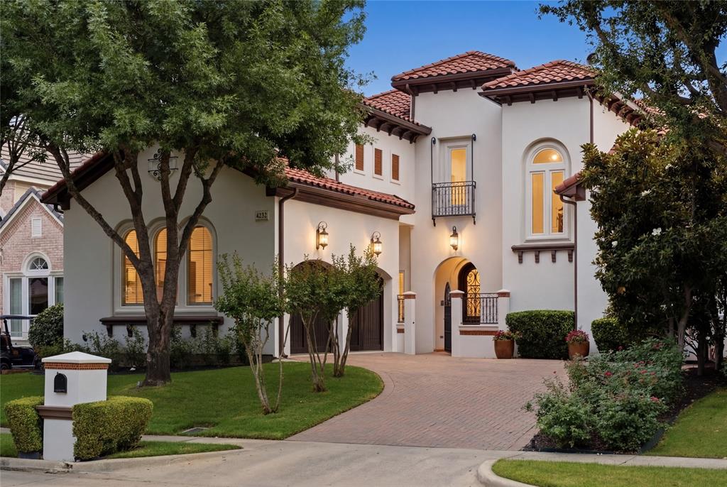Fully renovated custom Mediterranean estate by Michael Counter in guard-gated Fairway Vista, walking distance or a short golf cart ride along the connected cart path to the Ritz-Carlton Las Colinas and Nelson Golf & Sports Club. This 4-bedroom, 4.5-bath home spans 3,825 square feet and was comprehensively updated 2022–2023: new stucco, herringbone hardwood floors throughout, complete kitchen renovation, baths rebuilt to the studs, fresh paint, RH light fixtures in every room, both water heaters, and upstairs HVAC and furnace. Rare TWO PRIMARY SUITES — one on each level. The main-level primary (19x15) features a sitting area, sliding door to the covered patio, and a fully rebuilt spa bath with marble counters, dual vanities, garden tub, freestanding soaking tub, separate walk-in shower, and walk-in closet. The upstairs primary (17x14) offers its own sitting area, walk-in closet, linen closet, and garden tub bath — ideal for multi-generational living or single-level living with full guest accommodations. The chef's kitchen showcases all-new cabinetry, JennAir range and double ovens, gas cooktop, commercial-grade TRUE refrigerator and separate TRUE freezer, built-in wine cooler, quartzite island with 9-foot breakfast bar, and butler's pantry to the formal dining room. The two-story great room features built-in cabinetry and an electric fireplace. Two dedicated home offices on the main level. Upstairs adds a second living area, media room, wet bar, and private balconies off both ends of the hall. Outside: covered patio with attached grill and separate gazebo, wrought-iron fencing, and slate-and-tile roof inspected annually. Guard-gated 24-hour entrance. Minutes to Toyota Music Factory, Lake Carolyn, the Las Colinas Urban Center, and DFW Airport. A turnkey renovation in the heart of Las Colinas — live on one floor, entertain on two.