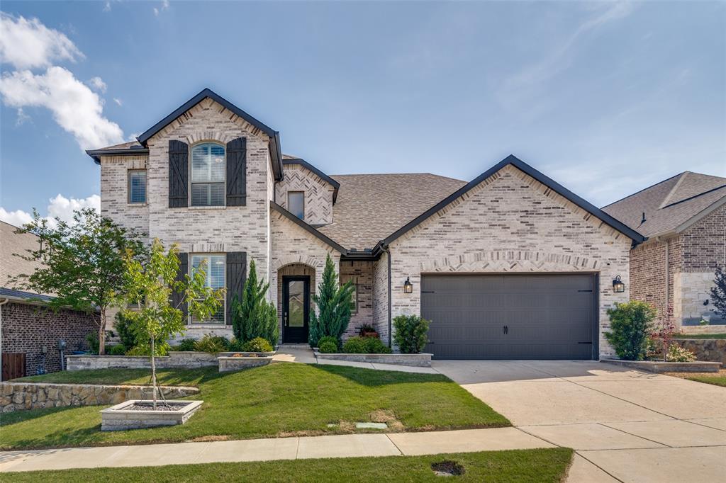 Nestled within one of North Texas’ most serene, lakeside, amenity-rich communities, this stunning custom residence by Highland Homes offers a rare blend of refined design, everyday functionality, and effortless luxury.
Thoughtfully designed for both entertaining and comfortable living, the expansive open-concept floor plan unfolds with warmth and sophistication, enhanced by rich wood flooring, a soft contemporary color palette, plantation shutters, and automated shades throughout. At the heart of the home, the beautifully refreshed kitchen serves as a true showpiece—featuring bright tiled backsplash accents, white quartz countertops, a generous island, walk-in pantry, stainless steel appliances, and oversized shaker-style cabinetry with glass fronts, all accented by premium matte black hardware and under-cabinet lighting.
With five spacious bedrooms and four full baths, the layout offers exceptional flexibility, including a private primary suite with an oversized closet and a separate downstairs guest bedroom—ideal for multigenerational living or extended stays. Dedicated spaces for work and play abound, including a private office, an oversized game room, and media room designed for immersive entertainment.
Step outside to an expansive backyard retreat, complete with a covered patio pre-plumbed for gas—perfectly positioned for future outdoor kitchen or fire feature enhancements. Updated hardscaping and exceptional curb appeal create a striking first impression, while the three-car garage with epoxy flooring adds both practicality and polish.
Energy-efficient lighting, thoughtful upgrades, and timeless finishes come together seamlessly in this exceptional home—offering a turnkey opportunity in a peaceful setting with access to premier community amenities.