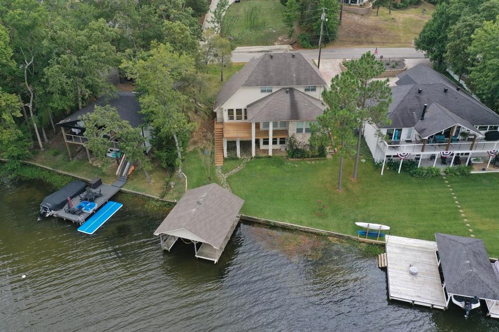 Welcome to this exceptional waterfront retreat in Hideaway, TX, where luxury meets serene waterfront living. This beautifully designed 4-bedroom home with 2 full and 2 half bathrooms offers breathtaking lake views and lush natural surroundings. With approximately 3,214 square feet of living space, the home provides an ideal balance of comfort, functionality, and elegance—perfect for everyday living and entertaining.

The open-concept floor plan features a spacious living area highlighted by vaulted ceilings, a striking stone fireplace, and expansive windows that frame panoramic lake views. The gourmet kitchen is thoughtfully appointed with granite countertops, custom cabinetry, and ample workspace, seamlessly flowing into the adjacent dining area ideal for both intimate meals and larger gatherings.

The main-level primary suite serves as a private retreat, offering tranquil lake views, a generous walk-in closet, and a spa-like en-suite bathroom complete with dual vanities, a soaking tub, and a walk-in shower. Three additional bedrooms provide comfortable accommodations with ample closet space.

Upstairs, a versatile bonus room offers flexibility for a bedroom, home office, media room, or play space, while the lower level includes an additional bonus room  to suit your needs.

Outdoor living shines with an expansive deck perfect for relaxing or dining while enjoying the scenery. The landscaped yard gently slopes to a private boathouse with storage for watercraft, providing endless opportunities for boating, kayaking, fishing, and lakeside enjoyment. The north-facing deck delivers stunning lake views.

Additional features include a two-car garage, laundry room, and abundant storage. Located within the gated community of Hideaway, residents enjoy 24-hour security, golf courses, swimming pool, tennis courts, and clubhouse access. Conveniently close to shopping, dining, and entertainment, this home offers a peaceful lakeside lifestyle just minutes away.