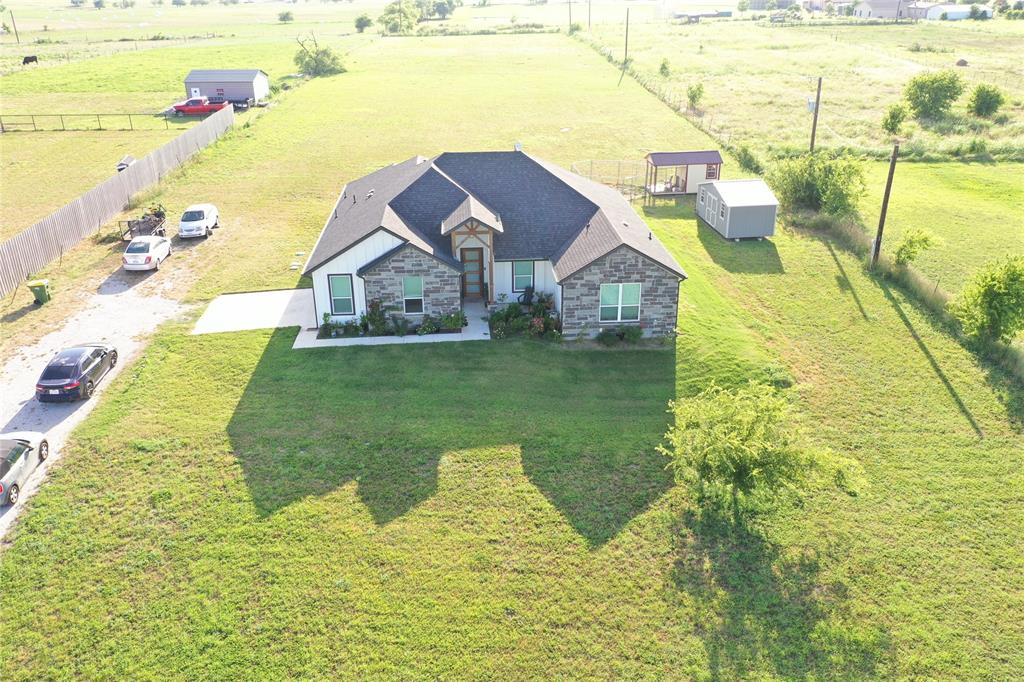 Discover a welcoming farmhouse set on 2.77 acres with easy access to Highway 287 for a quick commute to nearby cities; new home construction is beginning in the area and the seller is motivated. The open-concept main living area is ideal for entertaining and family life, anchored by a kitchen with a large island and stainless-steel appliances. The private master suite offers a separate shower and walk-in closet, while three additional bedrooms and two more baths provide flexible living space. Decorative lighting, durable tile, and cozy carpet run throughout, with abundant storage and parking for an RV, boat, or extra equipment. Horses are welcome on the property, and there are no HOA fees or city taxes — great country space with emerging neighborhood growth and a seller ready to make a deal.