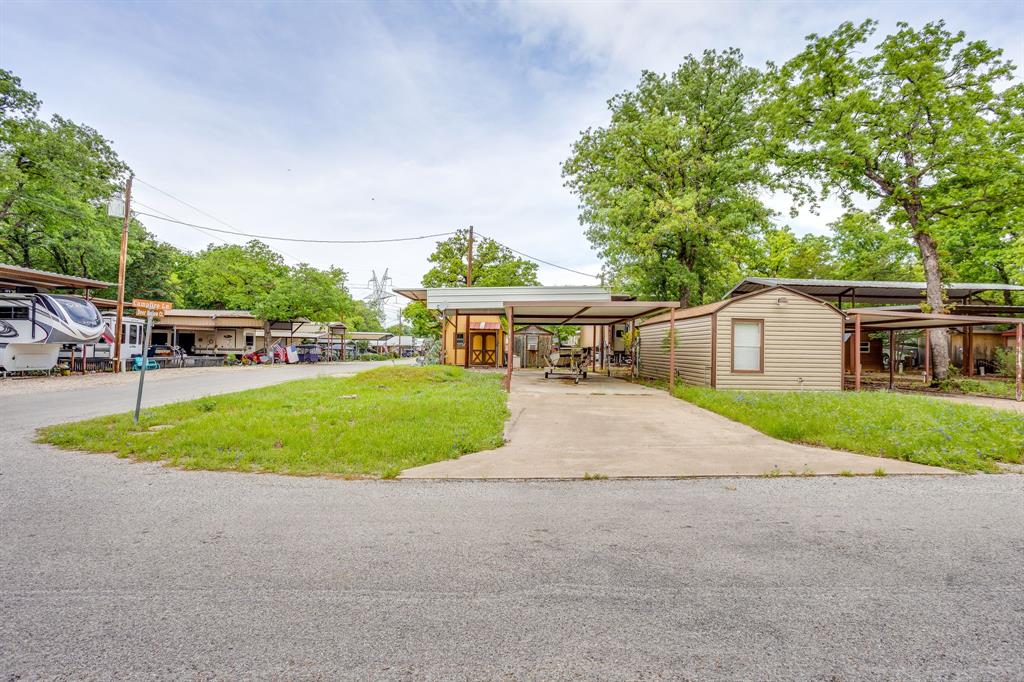 Just listed!! Welcome to the quiet life of country living at this beautiful RV community called Lake Granbury RV Ranch!! LOT 34 is a corner lot that features easy access to come and go as you please. The lot is perfect to store a boat, trailer or an additional vehicle. New residents can enjoy access to shared amenities including the pool and when needed access to four storm shelters. This lot is part of three that is up for sale. Lots 35 and 36 may be purchased together or separately. See the corresponding MLS#. 21250047