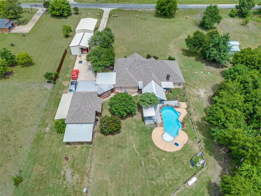 This is the UNICORN you have been looking for. Single story ranch style home with a pool, shop, RV parking on 6 acres. What more could you ask for? How about a second shop, nearly no neighbors(except cows) and the ability to have horses, cows, donkeys, goats or other farm animals(within local restrictions of course).  Four generous bedrooms, two full baths, two living areas and two dining area. HUGE covered deck space with bar and fireplace. Gorgeous pool with views of the land and trees. Horse stalls at the back of the garage. Those are currently used as tool storage by the owner. Could easily make that space into two horse stalls. There is also a separate barn that could be used to house animals of various sorts. Just far enough outside of the city to feel like you are in the country while being only 15 minutes from the Walmart in Wylie. Community ISD schools just around the corner. recent HVAC and water heater.