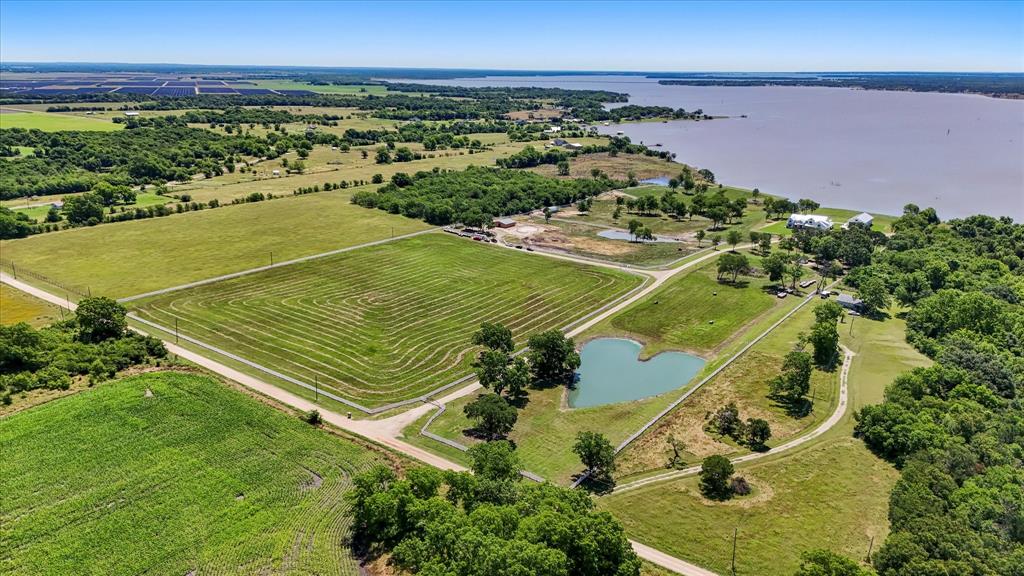 Natures Hearts Ranch is a 37 Acre Waterfront Sanctuary on Richland Chambers Lake! Every detail has been meticulously crafted to create unparalleled experience. Imagine the possibilities of this unique lakefront acreage with no HOA! The perfect place for a corporate retreat or a stunning venue to host events. 37 acres even offers room to develop a new lake subdivision! The main home and apartment are both custom homes that epitomize luxury living amidst the tranquility of nature. Main home is 6635 sf. 6 bedrooms, 5.1 baths, 2 offices, theater room, exercise room. 2nd floor living quarters accessible by elevator is perfect for hosting guests. Guest home with garage and workshop, includes 2,383 sf of living space, 4 bedrooms, 2 baths, kitchen, living, and laundry. For the equine enthusiast, 5 stall barn and tack room await. Outside is 1211 ft of shoreline with retaining wall, 3 ponds, swimming pool. Natures Hearts Ranch, where luxury and nature converge to create the ultimate retreat! Property is located in an opportunity zone!