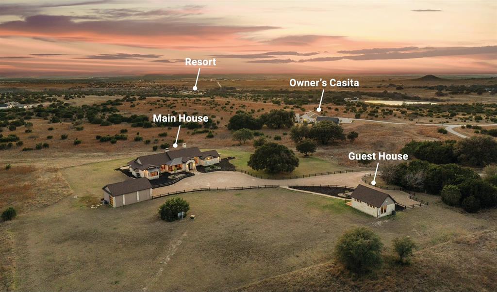 Luxury ranch estate on 50 acres inside the gated 9,000 acre Rough Creek Lodge & Resort community in Glen Rose, Texas. This multigenerational ranch property includes three residences with accommodations for up to 24 guests, ideal for extended family living, entertaining, or corporate retreat use.
The main residence offers 3,535 sq ft with 3 bedrooms and 3.5 baths, large windows with expansive Hill Country views, and elevated finishes. A separate owner’s casita features 2,427 sq ft with 2 bedrooms, 2.5 baths, private garage, and secure safe room. Additional guest accommodations include a 1 bedroom guest house with kitchen and living room, along with a party barn featuring 6 beds and 1 full bath.
The fully fenced 50 acre property features rolling terrain, open pasture, and a private fishing pond. Additional improvements include two climate controlled garages, two safe rooms, workshop, and custom dog wash station.
Ownership includes access to Rough Creek Lodge & Resort amenities including guided hunting, sporting clays, horseback riding, fishing lakes, miles of hiking and riding trails, tennis courts, resort style pool with water slide, zip line, archery, youth outdoor programs, family ranch experiences, fine dining, wine selections, massage and facial treatments, and concierge service.