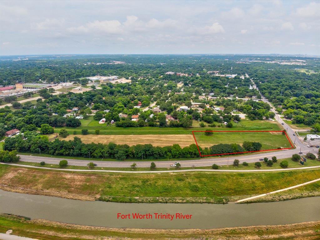 Over an acre commercial corner lot on White Settlement Road, the gateway to the River District with an unobstructed view of the Trinity River. Situated between downtown Fort Worth, Crestwood, restaurants, boutique office spaces, and a multitude of varying living options. Fort Worth has officially hit over a million residents and continues to be one of the FASTEST growing city's in the United States. This property has been studied for its highest and best use and falls within the city Neighborhood Empowerment Zone, meaning the city wants to see it improved upon. Unique opportunity to invest or create something special. Fort Worth as a city is supported by a robust economy, expanding infrastructure, and strong demographic trends. The local area features a stable population base, a growing workforce, and a supportive pro-business environment, further enhancing the site’s long-term investment appeal.