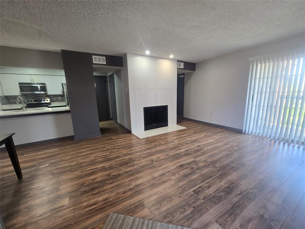 Fantastic move-in ready condo in the gated Creekbend Condominiums!  This second-floor unit 2 bedrooms, 2 full bathrooms, features an open floor plan with a cozy wood-burning fireplace, large windows for optimal natural light, and a private covered balcony perfect for your morning coffee.  The kitchen is fully equipped with modern appliances and opens to a designated dining space.  Large bedrooms with walk-in closet space and large windows yielding excellent natural light.  Includes assigned carport parking.  Enjoy amazing community amenities:  two pools, a tennis court, and a clubhouse.  Located in Richardson ISD and steps away from Richland College.  Situated just minutes from Richland College and providing seamless access to I-635 and Highway 75 makes any Dallas commute a breeze.  Don't miss this perfect blend of affordability, convenience, and community!  HVAC unit replaced in March 2021.