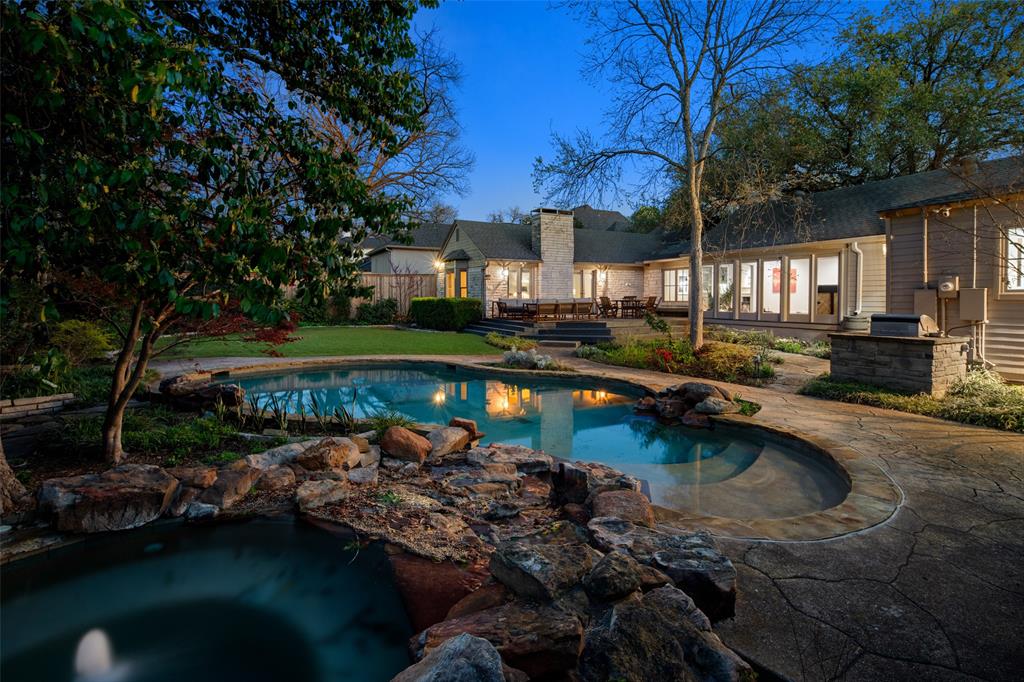 Set on an expansive 100 x 200 lot in the heart of Preston Hollow, this beautifully designed single-story residence offers 4,017 square feet of refined living. With 4 bedrooms, 4 full baths, and 4 distinct living areas, the home blends comfort, elegance, and functionality in one of Dallas’s most desirable neighborhoods. A welcoming stone façade and manicured landscaping create an inviting first impression. Inside, natural light fills the open spaces, highlighting thoughtful architectural details and a layout ideal for both everyday living and entertaining. Multiple living areas provide flexibility for a formal sitting room, media lounge, home office, or play space. The home’s seamless connection to the outdoors is one of its standout features. Large windows and doors open to a resort-style backyard complete with a sparkling pool and spa, generous decking, and a beautifully maintained lawn. It’s a private retreat designed for relaxation, gatherings, and year-round enjoyment. With its single-level design, spacious rooms, and exceptional indoor-outdoor flow, this Preston Hollow home offers a rare combination of luxury and livability on a premier oversized lot.