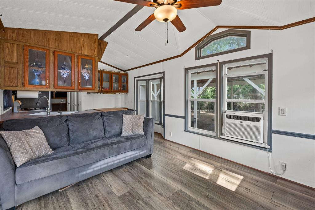 Located inside Indian Harbor gated community, this approximately 420sqft with an additional building that is setup as another bedroom at 184 sqft, this  tiny home offers a unique opportunity for downsizing, investment, or a weekend lake retreat. Nestled on a beautifully treed lot with mature shade trees, this property delivers both privacy and potential.

The home is move in ready, making it ideal for buyers looking to customize or add value. A separate insulated outbuilding with electricity and washer and dryer hookups provides incredible flexibility—perfect for conversion into a guest room, office, or additional living space.

Enjoy the convenience of covered parking, ideal for your vehicle, boat, or camper.

Indian Harbor residents enjoy access to amenities including a marina, boat dock, clubhouse, swimming pools, and gated security—bringing lake life and community living together in one place.