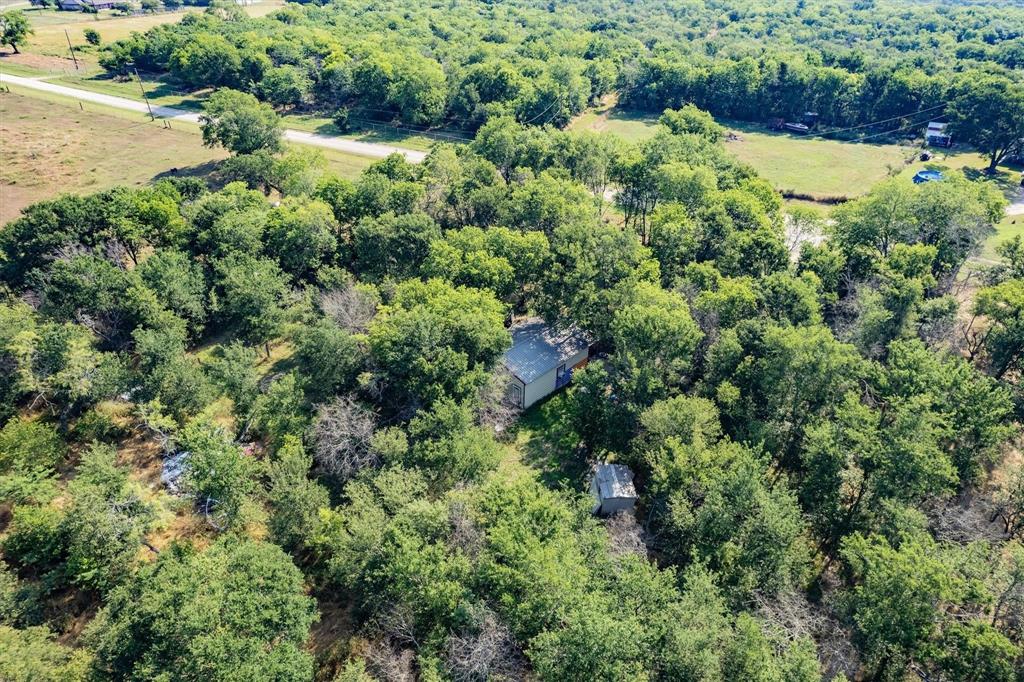 10 Acres in Navarro County with utilities, septic and living quarters!  This home is an 840 Barndominium with efficiency style apartment layout.  One big great room includes kitchen, living, dining, and sleeping quarters.  Private full bathroom has vanity and shower.  The barndo is perfect for a weekend getaway or a great place to live while you build your dream home in the country! This property is located outside of the city limits, so you get the benefit of no city taxes while only being 10 minutes from town! 10 acres is big enough for your home and all your animals!  The land is heavily treed and full of wildlife. Bring your boots so you can walk the property and see all it has to offer. Call today to schedule your property tour.  Because of land value being higher than barndo value this property will NOT qualify for typical residential home loan.  Financing options are available.  Call for more info on financing options and showings.