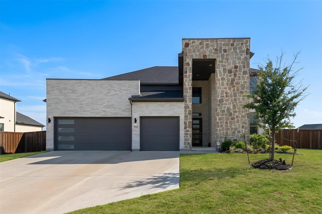 Huge backyard and potential swimming pool or pickleball court. Owner-occupied since new and never before leased, this home has been meticulously maintained and shows like a model. Striking modern two-story home offering 5 bedrooms, 4 bathrooms, and approximately 4,096 sq ft on one of the largest, fully-fenced lots in the community—zoned to the highly acclaimed Prosper ISD. The architecturally stunning exterior makes an unforgettable first impression: a soaring natural stone tower, clean white brick, contemporary flat-line rooflines, a sleek glass-panel garage door, and a private stone entry courtyard leading to a custom glass-and-wood front door. Inside, a dramatic two-story foyer with soaring ceilings, rich hardwood floors, and an elegant wood-and-wrought-iron staircase sets the tone for this light-filled, move-in-ready home. The heart of the home is an open-concept living, kitchen, and dining area crowned by a vaulted ceiling with a designer beam and modern chandelier. The chef's kitchen features gray shaker cabinetry, quartz countertops, a large center island with seating, stainless steel appliances, a gas cooktop, double ovens, a vent hood, and a classic subway-tile backsplash—all flowing seamlessly into the bright family room with a sleek linear fireplace and a wall of windows. A private first-floor study behind glass French doors makes the perfect home office, while the spacious primary suite—privately situated downstairs—offers a bay-window sitting area and a spa-like en-suite bath with dual quartz vanities, a separate frameless glass shower, a soaking tub, and an oversized walk-in closet. Upstairs, you'll find a large game room or loft, a separate media or bonus room, and generously sized secondary bedrooms with walk-in closets and updated baths featuring marble-look tile. Additional highlights include a spacious utility laundry room with extra storage and a covered back patio. 2 refrigerators and 1 freezer to convey with the property.