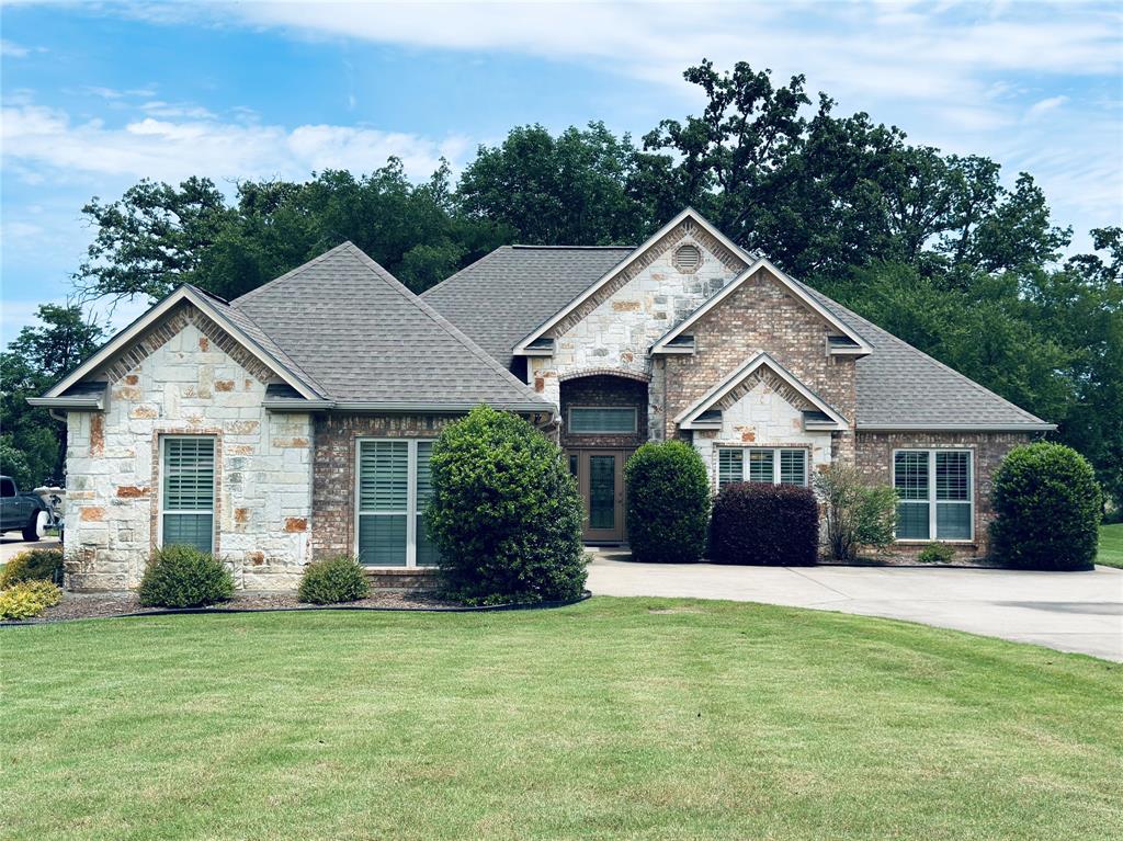Perfectly positioned on the legendary shores of Lake Fork, this custom-built waterfront retreat combines luxury, comfort, and timeless craftsmanship in one exceptionally maintained package. Offering 4 bedrooms and 2 baths — or the flexibility of a 3 bedroom layout with a dedicated office — this home was thoughtfully designed for both everyday living and lakeside entertaining.

Tucked away in a quiet cove with beautiful sunrise views stretching across the water, you’ll enjoy peaceful mornings from the enclosed sunroom or out on the covered boat dock, where good water depth makes boating and fishing easy year-round. Whether you’re chasing trophy bass or simply soaking in the serenity, this property delivers the true Lake Fork lifestyle.

Inside, the attention to detail is immediately apparent. The home features high-end finishes throughout, abundant storage in every corner, and custom electronic blinds that add both convenience and sophistication. The spacious living area is anchored by a gorgeous fireplace that has never even been used — a testament to just how meticulously this home has been cared for.

Built with quality in mind, the home includes extensive insulation for comfort and efficiency, while the flowing floor plan creates an inviting atmosphere perfect for hosting family and friends. Located in a desirable neighborhood with no HOA, you’ll enjoy the freedom to truly make this property your own without sacrificing the upscale feel of the community.

This is more than a waterfront home — it’s a rare opportunity to own a pristine, custom-crafted escape on one of Texas’ most sought-after lakes.
