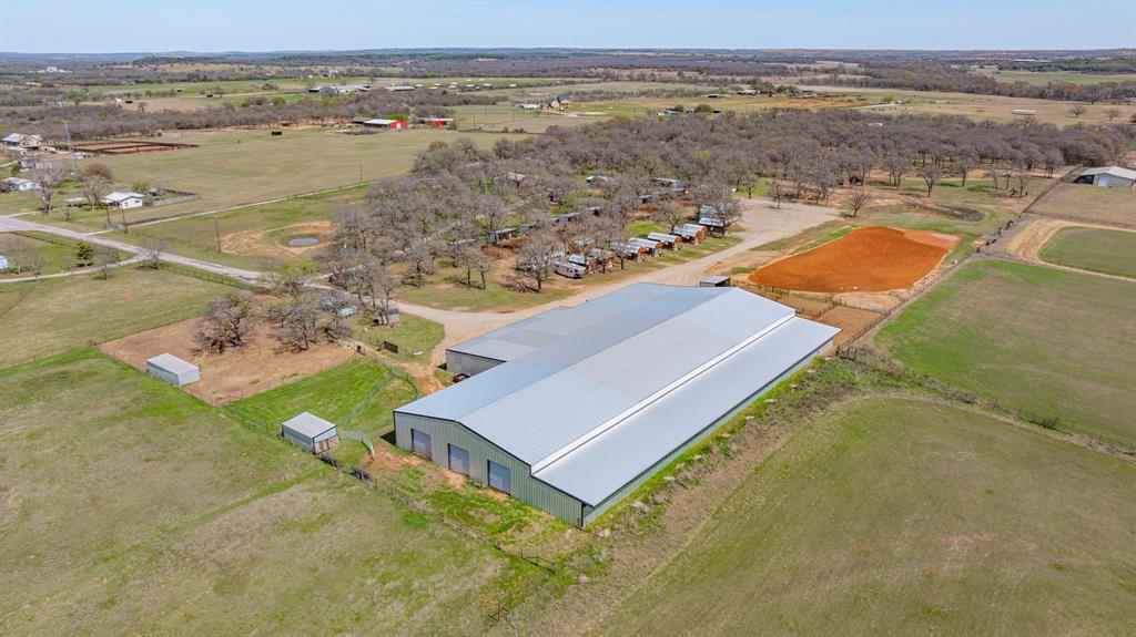 Nestled in the heart of Parker County, this versatile horse property offers the perfect blend of comfort, functionality, and income potential. The charming barndominium features a spacious living area, large kitchen with ample counter space, tile flooring throughout, and a loft-style bedroom with a private bath, double sinks, and walk-in shower. High ceilings with a chic metal finish add to the open, inviting feel.The home is attached to a large shop and a well-equipped 4-stall barn with a wash rack, making daily operations convenient and efficient.Equestrian amenities include an impressive 150' x 80' covered arena, an outdoor roping arena, multiple horse runs, shelters, and pasture space—ideal for training, events, or boarding.
Additional features include a private well, multiple septic systems, 10 income-producing cabins, and multiple RV hookups. Conveniently located with easy access to Hwy 51 and just a short drive to Weatherford and Fort Worth, this property offers peaceful country living with accessibility.
Endless possibilities—whether you're seeking a private retreat, business opportunity, or turnkey equestrian setup.