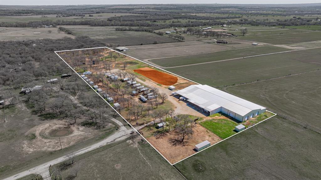 Nestled in the heart of Parker County, this versatile horse property offers the perfect blend of comfort, functionality, and income potential. The charming barndominium features a spacious living area, large kitchen with ample counter space, tile flooring throughout, and a loft-style bedroom with a private bath, double sinks, and walk-in shower. High ceilings with a chic metal finish add to the open, inviting feel.The home is attached to a large shop and a well-equipped 4-stall barn with a wash rack, making daily operations convenient and efficient.Equestrian amenities include an impressive 150' x 80' covered arena, an outdoor roping arena, multiple horse runs, shelters, and pasture space—ideal for training, events, or boarding.
Additional features include a private well, multiple septic systems, 10 income-producing cabins, and multiple RV hookups. Conveniently located with easy access to Hwy 51 and just a short drive to Weatherford and Fort Worth, this property offers peaceful country living with accessibility.
Endless possibilities—whether you're seeking a private retreat, business opportunity, or turnkey equestrian setup.