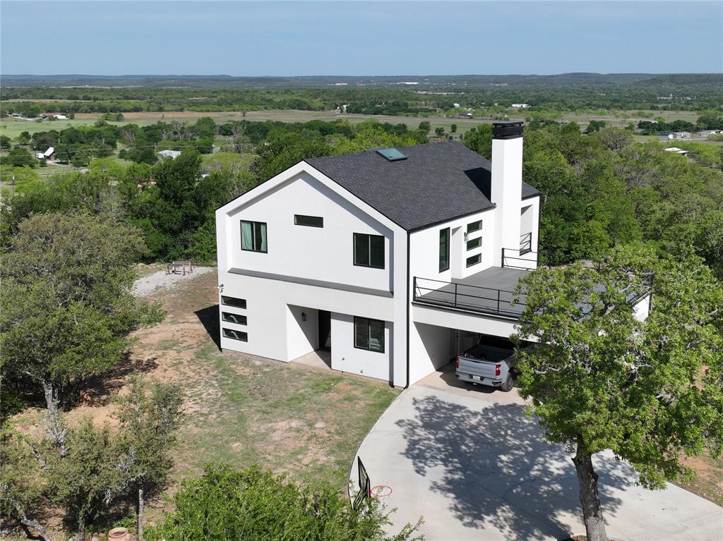 Picturesque all around views!!! This 2144 sq. ft. contemporary modern home sitting on 5.2 acres on Hog Mountain is a gem! The stucco exterior with a mix of metal and wood gives this house a perfect blend. The two story, 3 bedroom 2 and half bath house, sits about 600 feet off a cul-de-sac giving it a peaceful setting to enjoy the views, trees, large rock clusters and wildlife. The amazing views are a sight to see, especially relaxing on the balconies. Inside features of the house include decorative lighting, large skylight opening, floating stairs, kitchen island, open kitchen shelves, unique window designs, a fireplace, dual vanities in the full bathrooms and a garden tub. The large windows and skylights give an abundance of natural light in the house. The attic and exterior walls have spray foam insulation for energy efficiency. Don't miss out on this one!