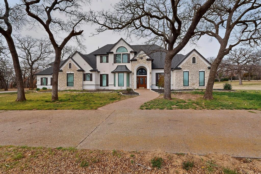 Stunning Estate in Sought-After Argyle situated on a beautifully treed 2.52-acre lot offers luxury functionality and exceptional indoor-outdoor living 5 bedroom 4.5 bath home features a thoughtfully designed floor plan with primary suite and secondary bedroom located on 1st Floor Primary retreat includes private sunroom with pool access a spa-inspired bathroom dual sinks jetted Jacuzzi tub walk-in shower built-in cabinetry The open-concept kitchen flows seamlessly into a secondary living area with an electric fireplace. Kitchen boasts an extra-large island built-in refrigerator 5-burner gas cooktop with vent hood built-in oven and microwave lighted cabinetry walk-in pantry breakfast room Upstairs offers flexible living options a large entertainment room with two closets plus a fifth bedroom that can easily function as a private media room or secondary office Two additional upstair bedrooms one with a private bath and one adjacent to a full bath Backyard oasis is complete with a pool featuring a waterfall and covered patio ceiling fan ample yard space surrounded by mature trees perfect for summer gatherings Dual staircases Dedicated office w built-in cabinetry ceiling fan Formal dining room and spacious living areas Plantation shutters downstairs windows Hardwood flooring downstairs tile in master bedroom kitchen and baths engineered wood flooring upstairs Laundry room downstairs with sink, built-in cabinets, and storage closet Two tankless water heaters The 3-car garage features insulated doors, new openers, and built-in cabinetry. A large circular driveway. This exceptional property combines luxury finishes, versatile living spaces and resort-style amenities all in one of Argyle’s most desirable locations Recent updates include Energy Efficient Windows Replaced 2023 Roof 09-2025 Kitchen Remodel 10-2022 Insulated Garage Doors and Door Openers 12-2025 This property delivers upscale finishes versatile living spaces all in one of Argyles most desirable neighborhood