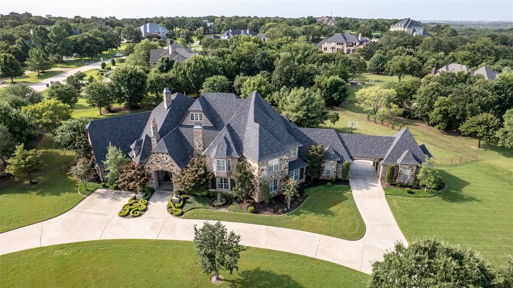 Magnificent resort-style living on 2 acres in the prestigious 24-7 guarded and gated Estates of Tour 18 golf course community. Large corner lot with circle drive and gated porte-cochere to 4 car garage.  Designed for entertaining with a large game room and media room on the 1st floor with an outside patio and outdoor kitchen surrounded by entrances to the game room, open family room & primary suite.  The primary suite has an exercise room and sauna. Kids will love the 2nd upstairs game room with a balcony. Three large bedrooms, all with walk-in closets, and an additional bonus room for the kids and friends to hang out in. 1st floor Guest suite includes a large bedroom and a separate living room. The floor plan is the home's most vital point, along with great curb appeal, 4 car garage, and located on a peaceful cul-de-sac lot. Served by award-winning Argyle ISD and Liberty Christian schools. Access to major highways, local shopping and dining, and UNT and TCU Universities.