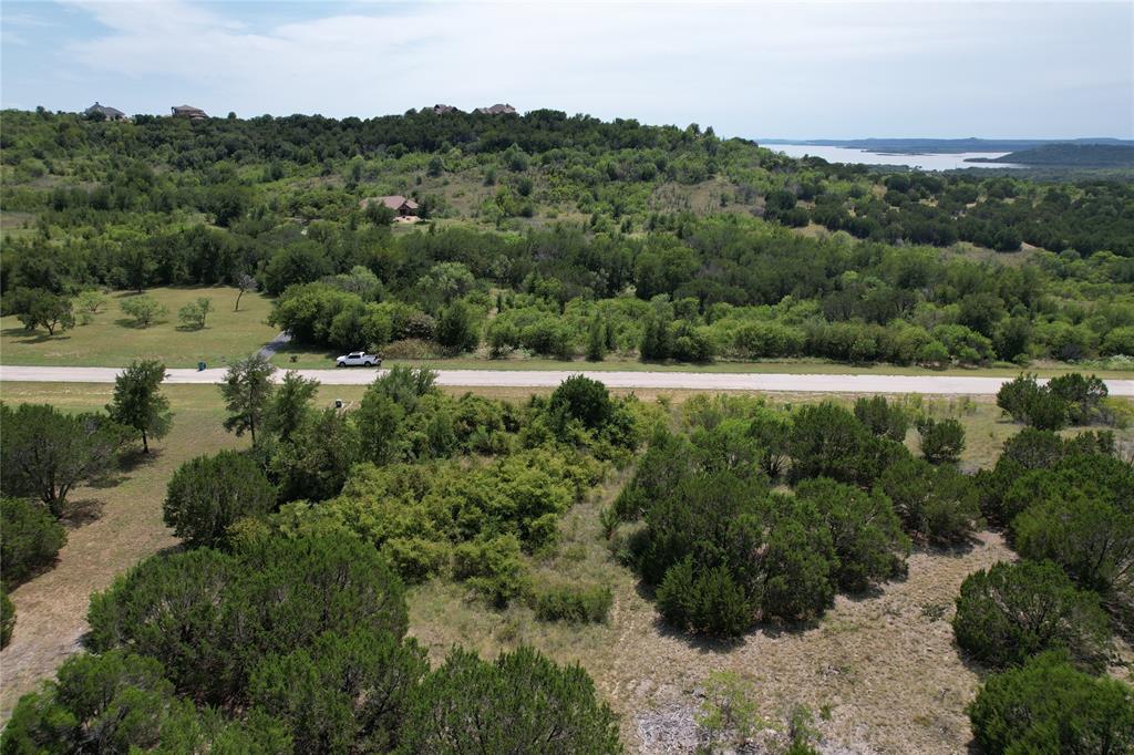 This two acre lot in the scenic and peaceful Hills Above Possum KIngdom is ready to build on. Enjoy nature and serenity and enjoy all the amenities of this neighborhood including; boat storage, boat ramp, community dock, clubhouse with pool and fitness center, cabin on the lakefront with picnic area and covered patio, fishing pond and park area, secure gates, and twenty miles of private roads.