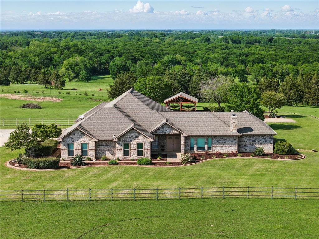 Positioned just outside the McKinney city limits in a rapidly developing corridor, this nearly 45-acre ag-exempt property offers a rare combination of location, infrastructure, and long-term potential. With frontage along County Road 471, the land is fully fenced, cross-fenced, and currently used for agricultural purposes—but the future use options are far-reaching. Whether you’re looking for a private estate, equestrian retreat, small-scale development, or a strategic long-term hold, this property checks all the boxes.

A gated entrance welcomes you into gently rolling pastureland with a peaceful tank near the treeline. Two detached shops sit away from the main home, ideal for storage, equipment, or staging future construction. A city-planned park nearby will further elevate the long-term value, anchoring this property within a growing residential and community infrastructure footprint. With no known restrictions and located in McKinney ISD, this property is flexible and well-positioned for future resale or phased development.

The single-story brick home offers over 4,100 square feet with five large bedrooms, four bathrooms, and wood flooring throughout the main living areas. A dedicated office provides space for working from home or property management. Two generous living spaces create flexible zones for personal use or entertaining. The kitchen features double ovens, modern updates, and connects to a dining space framed by wraparound counters. The home also includes both an electric fireplace and a wood-burning fireplace, bringing comfort and charm.

Utilities are in place, and the property’s location just minutes from Highway 75 provides direct access to McKinney’s commercial core, nearby schools, and regional development. With growth moving north and east, this property represents a rare chance to invest, live, or build in one of Collin County’s most promising areas.
