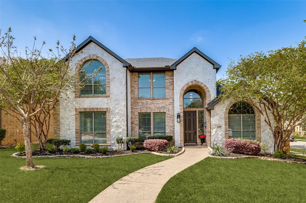 Located in the highly sought after Castle Hills community, this beautifully maintained 5-bedroom home offers a popular layout, thoughtful updates throughout. With 2 bedrooms downstairs and 3 upstairs, this is a true 5-bedroom home with flexibility for a variety of lifestyles, plus a spacious dedicated office and a statement entryway with vaulted ceilings and great natural light.
Step inside to an open floor plan, rich hardwood flooring, standout staircase, and updated fixtures and lighting that give the home a fresh, elevated feel. The hard  to find expansive main living area flows seamlessly into the kitchen and breakfast space, creating an ideal setup for both everyday living and entertaining. The kitchen is equipped with granite countertops, stainless steel appliances, double oven, gas cooktop, and a large island with plenty of prep space and storage, all overlooking the living room and backyard. Upstairs, you’ll find a large game room with built-in wet bar, perfect for entertaining or a second living space, along with a dedicated media room for movie nights at home. The additional bedrooms are generously sized, with one being oversized and ideal for a guest suite, playroom, or second living area, and offer great flexibility for family or guests. 
The primary suite has hardwood flooring, abundant natural light, and a spacious layout. The ensuite bathroom includes vanities, a soaking tub, separate walk-in shower, and large walk in closet. 
Step outside to a private backyard designed for both relaxation and entertaining. Enjoy an extended patio with durable Trex decking, custom wraparound stairs, and an outdoor kitchen complete with a grill and wet bar. Beyond the home, Castle Hills offers an unmatched lifestyle with community amenities including pools, parks, playgrounds, walking trails, scenic water features, and nearby Village Shops with dining and retail just minutes away. Lewisville ISD and Castle Hills Elementary!