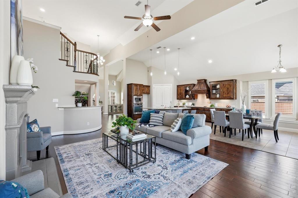 From the moment you step through my front door, the grand staircase, soaring vaulted ceilings, and expansive windows create an immediate sense of arrival. Multi generational living set up with primary bedroom and guest bedroom downstairs with full bathroom, and 3 bedrooms upstairs. Natural light pours into every corner, making the engineered hardwood floors glow with life and highlight details that elevate each space—from elegant chandeliers to plantation shutters. My formal living and dining rooms are spacious and eligant, while the heart of the home balances beauty and function. Natural wood cabinetry, stainless steel appliances, designer backsplash, island, built-in wine rack, and the breakfast nook create a kitchen that naturally draws everyone together. Just beyond, a warm fireplace anchors the main living area, while the wet bar stands ready for celebrations both large and small. Settle into the media room for movie night, or step outside to the covered patio overlooking a sprawling backyard with ample space for a future resort-style pool. This custom home was designed with comfort, connection, and memorable experiences in mind. The primary suite offers a private retreat worthy of its scale. The spacious bath features dual vanities and a garden tub separate from the tiled shower. Behind the scenes, significant improvements provide peace of mind, including fresh interior paint, updated light fixtures, all new window screens, and a roof replaced in 2024. And don't forget my surround gutters. Nestled within the prestigious Estates of Verona and served by acclaimed McKinney ISD, this residence enjoys access to the lifestyle that has made McKinney one of North Texas' most sought-after destinations. Spend evenings dining at Rick's Chophouse, Harvest, Local Yocal, or The Yard. Explore the boutiques and charm of Historic Downtown McKinney, enjoy one of the many nearby golf courses, or play a game of Cricket at nearby parks.