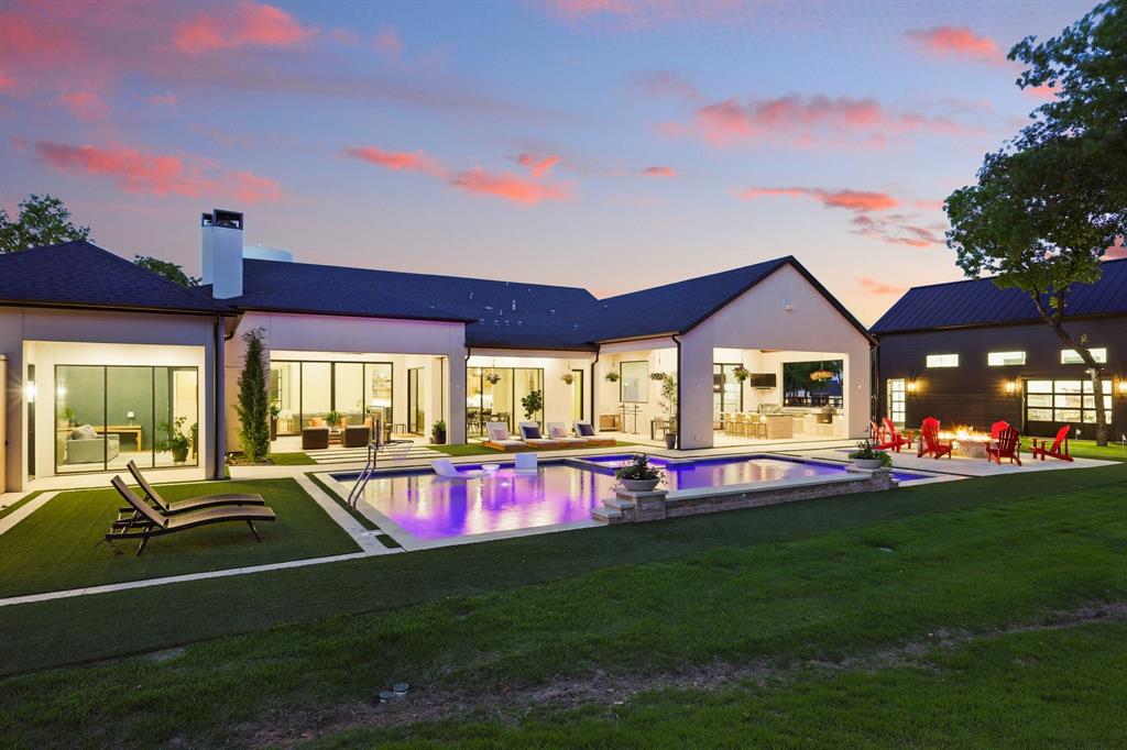 This modern mid-century ranch home, built in 2023,  is a true masterpiece blending luxury with intentional design. Its single-story layout with complete privacy, emphasizes both functionality and style, offering a spacious, open-concept living area that seamlessly integrates the living room and kitchen, creating the perfect space for entertaining. The strategic separation of the bedrooms enhance the homes livability. 
Outside, the entertainment possibilities are endless. The large, covered cooking area serves as the focal point for outdoor gatherings, featuring a built-in bar top seating area where guests can enjoy drinks while interacting with the chef. A cozy fire pit offers a perfect spot to unwind, creating a warm and inviting atmosphere for evening relaxation. This home isn't just a living space; it's a destination for luxury living and unforgettable gatherings.

Key Features:
Gun safe room with Fort Knox Door
Remote control screened in porch
Greenhouse with WiFi capabilities 
Whole House Water Filtration System 
Instant Boiling and Chilled Water Faucet
Large wine refrigerator
Full-Size Batting Cage
Large Putting Green
Diving Pool with Basketball Goal
Access to multiple ponds
Large detached garage
Sauna