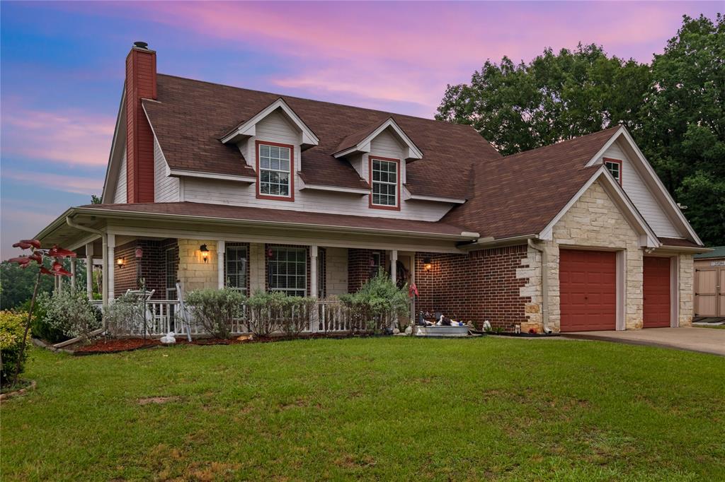 Welcome home to this beautifully crafted 2-story custom home, perfectly situated on 3.21 acres with scenic pond views. Built in 2005 and offering 1,657 square feet of thoughtfully designed living space, this 3-bedroom, 2.5-bathroom property masterfully combines classic curb appeal with a relaxed, country lifestyle. An attractive pipe and brick gated entryway opens to a long, winding driveway that cuts through a massive, beautifully manicured front lawn shaded by mature trees. The home features a stunning wrap-around porch that spans the front of the house, the absolute perfect spot to sit in the shade, look out across your expansive acreage, and enjoy the water views. The property backs up beautifully to a large, shared pond, offering you easy waterfront access right from your backyard. Inside, you will find a large, bright, and open living room centered around a cozy wood-burning fireplace flanked by custom built-in shelving. The main floor also includes a formal dining room and a bright breakfast area complete with a custom built-in hutch. The kitchen is a chef's delight, offering a functional layout with a breakfast bar and an abundance of cabinet space. For maximum convenience, the spacious primary suite is located on the ground floor, featuring a full bath with double sinks and walk-in closets. Upstairs, are two additional bedrooms and a second full bath, giving family or guests their own distinct space. A handy half-bath is perfectly situated off the kitchen and laundry area, leading right into the attached garage. With over 3 acres of land to stretch out on, great craftsmanship, and waterfront perks right out your backdoor, this home is a must-see. Schedule your private tour today!