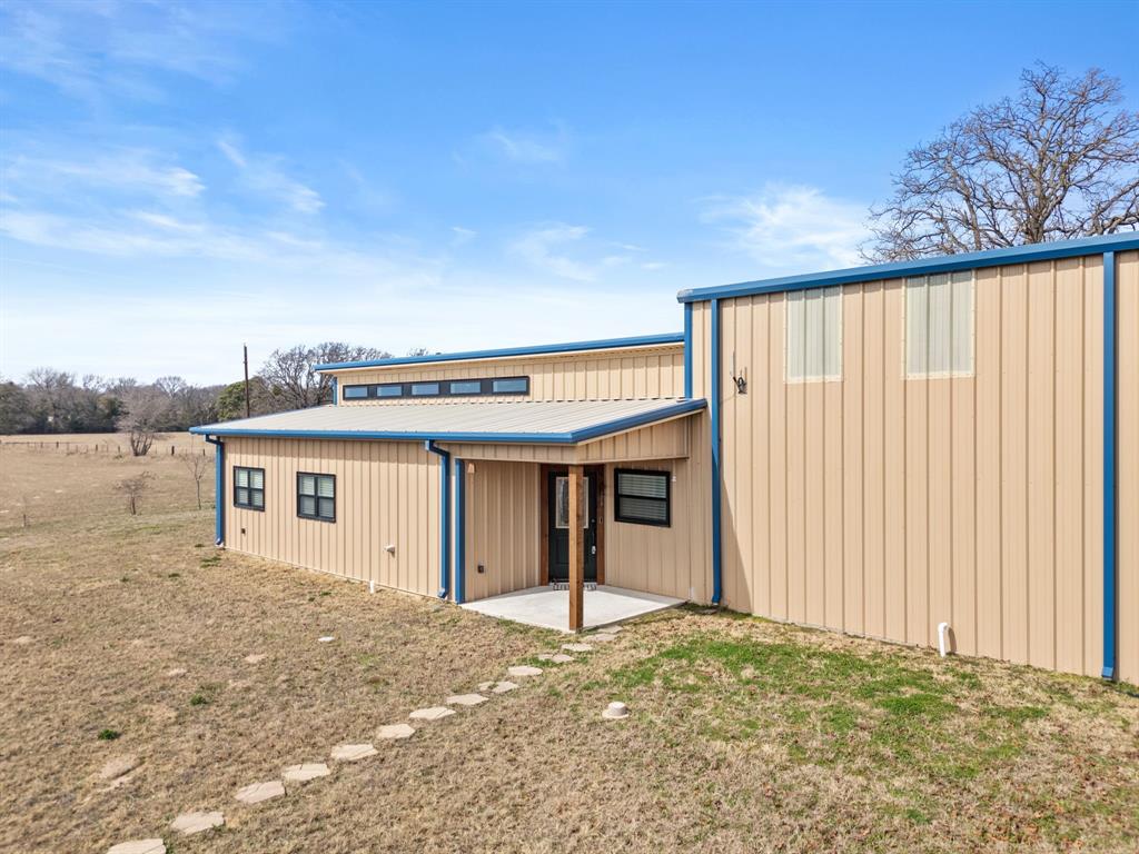 SPECIAL OWNER FINANCING AVAILABLE!! 
This 2022-built home is a rare find for RV owners and outdoor enthusiasts! 0.644 acres located on the north side of Mineola, TX— no HOA just space, privacy, and freedom. The property features a massive 1,860 Sq. Ft. insulated garage and shop with a 14 ft. door and a full 50-amp RV hookup — perfect for your RV, boat, or fifth wheel. There’s even room for two additional vehicles and a large loft for extra storage or workshop space. Inside, the home offers 1,574 Sq. Ft. of comfortable living space with 2 bedrooms, 2 full baths, plus a half bath for guests. The kitchen boasts granite counters, ample cabinet space, and a gas range. The primary suite features dual vanities, a walk-in shower with three shower heads, a full soaking tub, and aerial windows with remote-controlled blinds. Modern amenities include a tankless gas water heater and fiber optic internet. Enjoy lake adventures with Lake Holbrook just 3.5 miles away and Lake Fork only 13.5 miles from home. The metal siding and roof make maintenance easy, while the expansive lot provides space for pets, gardens, or additional outbuildings. Whether you’re a full-time Rver, weekend adventurer, or snowbird, this property is the perfect home base for your lifestyle.