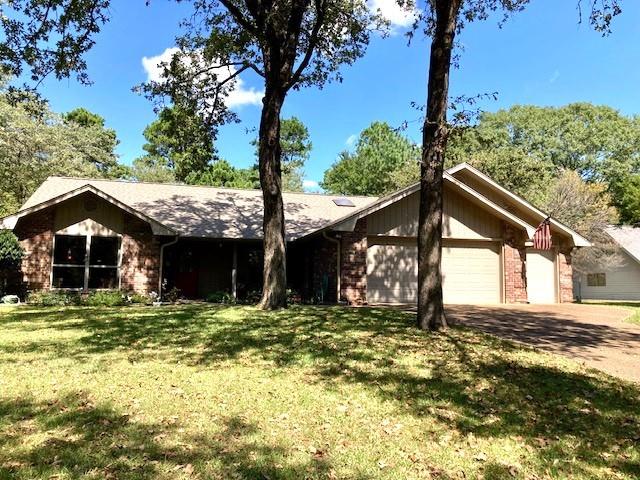 Traditional home set on a level lot in a guarded gated HOA community in the beautiful piney woods of East Texas. Enter through the decorative front door into a spacious entry. To your left is the light filled living room with a broad view of the front yard and mature oak and pine trees. On to the kitchen, family room and dining area. The pantry has roll out shelves with plenty of storage. The dining room has a skylight and there is a separate seating area. On out to the sun room to the spacious deck area. In season enjoy a 50' row of pink azaleas. Also, two rows of knockout roses and a vegetable garden. Sit on the deck, have a lemonade and enjoy the peace and quiet and the birds. Back into the two car garage adjoining golf cart garage. HVAC new in 2023. Holly Lake Ranch has many amenities: golf, pool, pickle ball, tennis, putt putt, disc golf, and a swim beach. Fish in two well stocked lakes with concrete boat ramp. Holly Lake Ranch is 50 minutes north of Tyler and 2 hours east of Dallas Love Field.