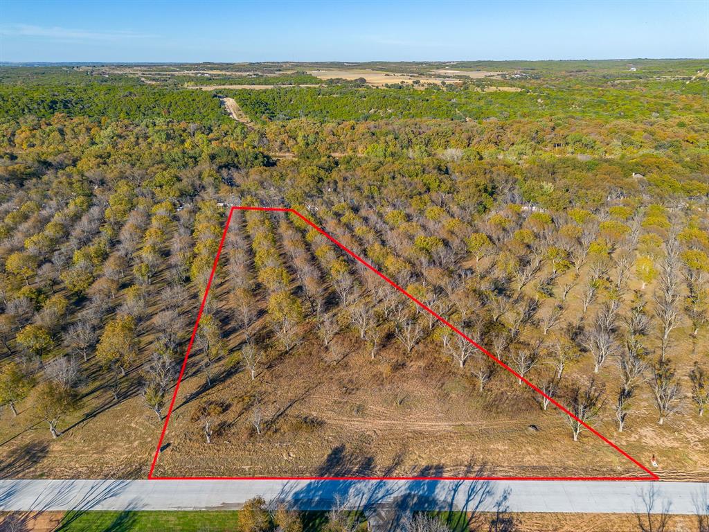 Howdy! Welcome to The Ranches neighborhood of Pecan Plantation Phase 1. LOT 3657, 3030 E Landgins N, 2.688 acres. Lot dim 343 x 650 52 X 586. Available totally in HOOD County. Site is complete with paved roads, underground electric service, AMUD water, septic required, Orchard irrigation & fiber optic high speed internet available. Choose any builder you would like and no time frame to build. Min SQ FT 2,200. This LOT is full of thriving Pecan trees. You must keep 8 on property. Bring your HORSE, they will love the sandy loam soil and miles of equestrian trials. Home back up to the Equestrian trail.  Discover the exceptional lifestyle of Pecan Plantation, a private, gated community nestled along 17 miles of the historic Brazos River within a 4,200 acre pecan orchard. Enjoy resort style amenities including two championship golf courses with full practice facilities, a full-service clubhouse with multiple dining options, marina with access to Lake Granbury, tennis & pickleball courts, pools, dog park, riverside parks, Airparks, camping, & 24 7 security with Fire & EMS services. The Village, features a bank, grocery store, restaurant, Pecan Medical Clinic, PT Services, pharmacy, golf cart shop, Vet Clinic, car wash, & Ace Hardware. Just minutes from the Historic Granbury Square officially the “Celebration Capital of Texas” under an hour from Fort Worth. Experience the perfect blend of tranquility, recreation, and convenience. Come see why you’ll want to build your dream home here! PPOA Mandatory Membership as of 9-1-25: PPOA Transfer Fee $1,091.00 + 73.65 (tax) = $1,304.49. Initiation Fee $4,381 EQUALS: $5,545.65 The monthly fee is $204.75 and includes trash service or $182.75 without trash service. Search YouTube 'Airplane Ride Around Pecan Plantation Rebecca Van Buren' to learn about our amazing community.