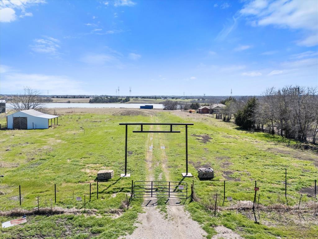 Looking for the perfect lakefront acreage to build your dream home? This picturesque 4.6± acre lot welcomes you with a stately iron entrance, setting the stage for a serene and private retreat. With ample space for your ideal home design, this property offers endless possibilities to craft your personal haven. Nestled in a prime location, enjoy the best of both worlds—peaceful country living with the convenience of nearby top-rated schools and easy highway access for a smooth commute. A covered metal storage shed is already in place, providing practical storage for outdoor gear or equipment.
Bring your vision to life and build your dock, where you can fish, canoe, or simply take in the tranquil lake views. Don’t miss out on this rare opportunity to own a slice of waterfront paradise—schedule a tour today!