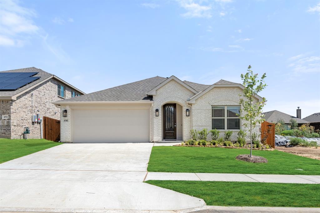 NEW! NEVER LIVED IN. READY NOW! Experience the Camellia floorplan by Bloomfield Homes in Hulen Trails, a 3 bedroom, 2 bath single-story home with a 2-car garage layout. Curb appeal begins with a bricked exterior, front porch and an impressive 8-foot front door that creates a welcoming first impression. Full rain gutters add lasting performance, while a covered rear patio extends your living space outdoors for relaxing evenings. Natural light pours through tall windows that overlook the backyard, giving the main living areas an open and refreshing feel. Quartz countertops are featured throughout the home, adding a clean and cohesive finish. The kitchen offers generous prep space and storage, while the nearby utility room includes a functional mud room area that helps keep daily routines organized. The primary suite is privately positioned and features a spacious vanity, standing shower, and a huge walk-in closet designed to keep everything within reach. 2 secondary bedrooms are thoughtfully arranged near a full bath, offering flexibility for guests, hobbies, or a home office. Additional upgrades include 2-inch faux wood blinds throughout and a tankless water heater for modern efficiency and comfort. Residents of Hulen Trails enjoy access to scenic trails, a soccer field, community pool with bathhouse, dog stations, playground, greenbelts, and a neighborhood park, offering plenty of ways to relax and stay active. Don’t miss your opportunity to tour the Camellia at Hulen Trails and make it yours!