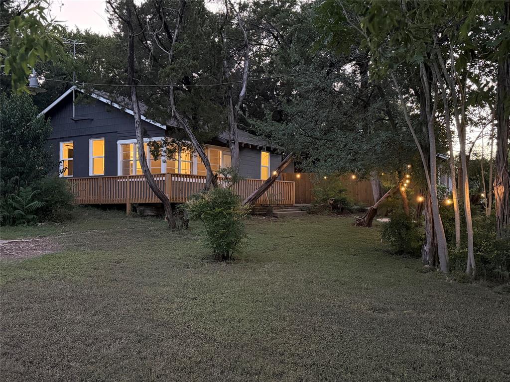Perfect small lake house very close to Whitney Ridge Marina.    Remodeled, with nice flooring, very nice kitchen, 2 small bedrooms, den and dining area open together.    Enclosed front porch.   New deck on the front and one side of the house.   Small back yard with a privacy fence makes it a perfect little area with plenty of privacy.    Brand new roof installed recently.

The lot is a huge corner pie shaped property.   Lot's of potential with this property.    

This property is across CR 1700 from Mr K's store.