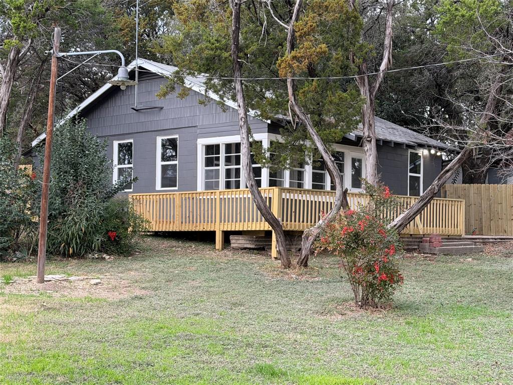Perfect small lake house very close to Whitney Ridge Marina.    Remodeled, with nice flooring, very nice kitchen, 2 small bedrooms, den and dining area open together.    Enclosed front porch.   New deck on the front and one side of the house.   Small back yard with a privacy fence makes it a perfect little area with plenty of privacy.    Brand new roof installed recently.

The lot is a huge corner pie shaped property.   Lot's of potential with this property.    

This property is across CR 1700 from Mr K's store.