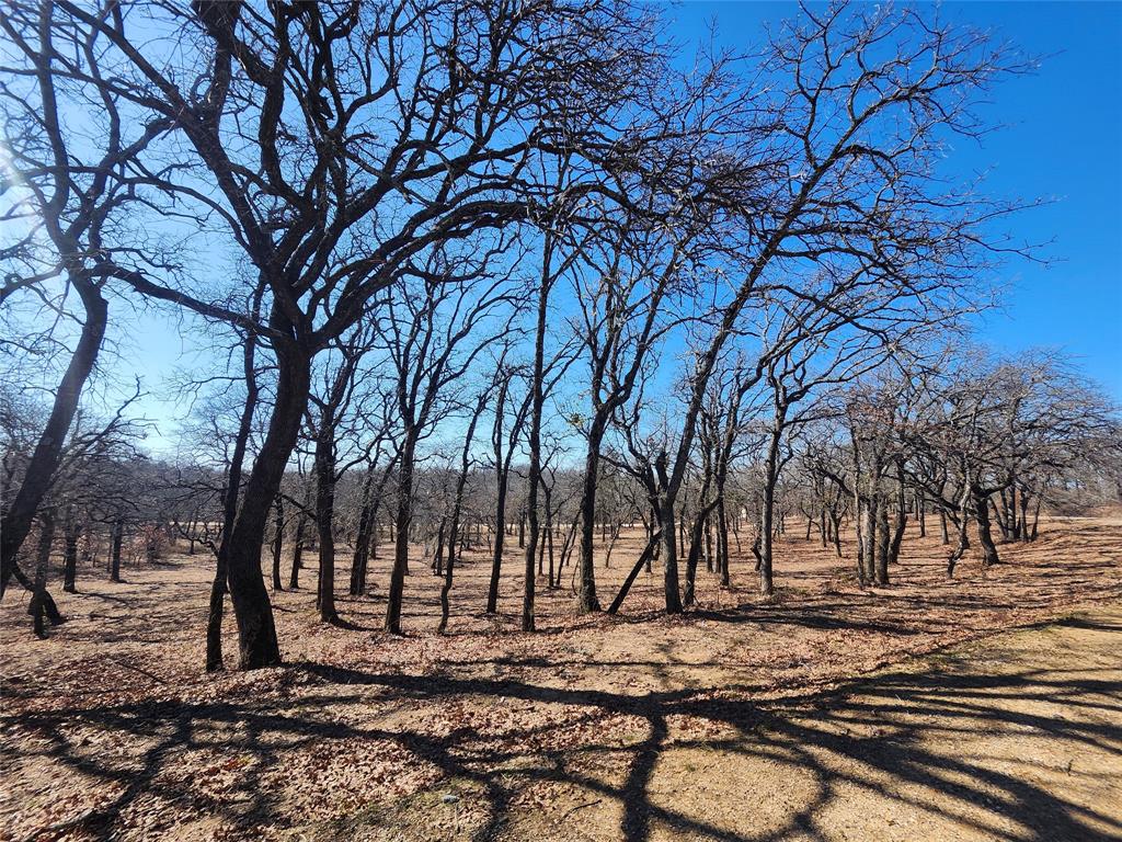 Beautiful Building site corner lot just over a acre and a half for space to spread out, room for a shop. Mature Oak trees, cleared off ready for building on. Lots are surrounded by the tranquility of nature as you will often see deer all around the property. Nocona Hills offers a 24-hour guarded gated community with access to two private lakes (one listed as top 5 Bass fishing in Texas)a community boat ramp and dock, as well as an 18-hole golf course with driving range, an airstrip, campgrounds with RV sites, and more. Utilities include co-op water and electric already at street. Fiber optic high speed internet is also available. Nearby surroundings include historic downtown Nocona, a winery, brewery and just a short drive to Saint Jo, Muenster and popular Casinos. Come see this gem. 
Owner has many lots available to choose from, please contact listing agent for details.  The Club house is under remodel along with the pool such an exciting new Update for the community.
