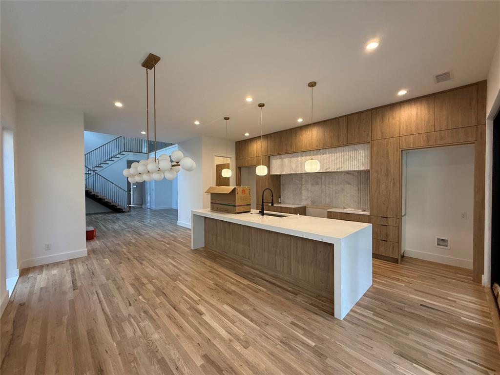 This newly constructed modern duplex by Conrad Homes offers a refined take on contemporary living with superior design, finishes, and an exceptional location. Thoughtfully designed for both everyday comfort and effortless entertaining, the open-concept main level showcases soaring ceilings, expansive natural light, and a chef’s kitchen anchored by an oversized island, stainless steel appliances, and a generous walk-in pantry.

Expansive sliding glass doors connect the living space to a private backyard retreat featuring a large covered patio and outdoor gas fireplace, creating a year-round extension of the home that’s perfect for relaxing evenings or hosting guests. An 8-foot board-on-board fence provides exceptional privacy and security.

Upstairs is complemented by two well-appointed guest bedrooms, each with an en suite bath, and a full-size utility room with built-in cabinetry and a sink. The primary suite is a true retreat, complete with a spa-inspired bath featuring a walk-in shower, soaking tub, and oversized walk-in closet.

Ideally positioned just minutes from premier dining, shopping, and entertainment in the Lower Greenville neighborhood, this home delivers the perfect blend of modern luxury and lock-and-leave convenience.