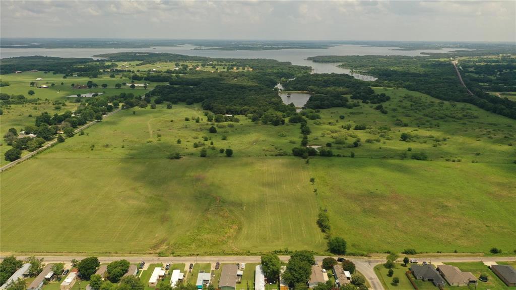 Private lakefront property on approximately 20 acre lake. Great ranch or development property with beautiful acreage. Minutes from downtown Pilot Point City Center and less than 2 miles from Ray Roberts Lake State Park, the most visited State Park last year with 885,000 visitors! Front (south) acreage of property is in city limits and back (north) piece of property is in Denton County, allowing flexibility for access to utilities. Electrical and sewer accessibility available at Holford St. Ag exempt. This listing can be combined with MLS# 20538203, 59.83 acres for  approximately 105 acres total.