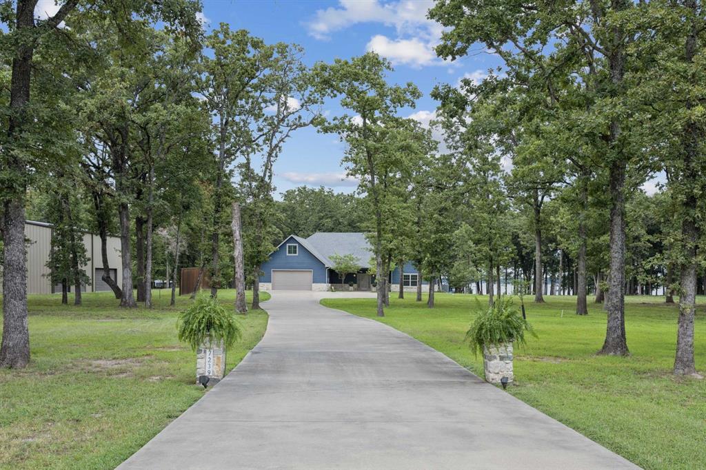 Set on the shores of Lake Tawakoni in the heavily treed Nautical Shores subdivision, a lovely custom home sits on a one-acre waterfront lot. The home's interior features three en-suite bedrooms, a half bath, a cook's kitchen, a living room, and an office. The attic spans the full length of the house and could easily be converted into a media room, game room, or additional living space. 

The home is situated midway on a large lot, surrounded by numerous trees, and offers a stunning waterfront view. At night, the trees are lit, creating a beautiful setting to enjoy from the large electric screened-in back porch. 

The subdivision is beautiful, quiet, and serene, with each lot well-maintained.  The home is dock-ready, but Nautical Shores also features a marina for residents.
