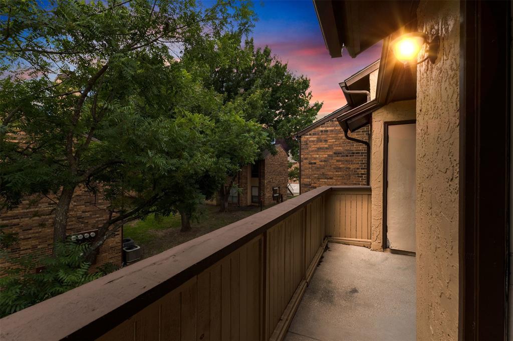 Welcome to The Cloisters, one of Arlington’s most desirable gated condominium communities! This beautifully updated 2-bedroom, 2-bath condo offers 1,025 square feet of comfortable, low-maintenance living in an unbeatable location near AT&T Stadium, Globe Life Field, Texas Live!, Six Flags, and countless dining and entertainment options.

Step inside to find luxury vinyl plank flooring, a spacious living room with a cozy wood-burning fireplace, and an open dining area perfect for everyday living or entertaining guests. The galley-style kitchen features Corian countertops, a breakfast bar, pantry, ample cabinet space, and includes the refrigerator.

The primary suite offers an ensuite bath with dual sinks, built-in storage, and a linen closet, while the secondary bedroom features a walk-in closet and easy access to the second full bath. Additional conveniences include a full-size utility area and two assigned parking spaces.

Residents enjoy the security of a gated community along with HOA-covered amenities that include water, sewer, trash, exterior maintenance, grounds maintenance, insurance, and full use of community facilities. Whether you’re a first-time homebuyer, downsizing, or searching for an investment opportunity, this move-in-ready condo delivers exceptional value in the heart of Arlington.

Schedule your private showing today and experience convenient, lock-and-leave living at The Cloisters!