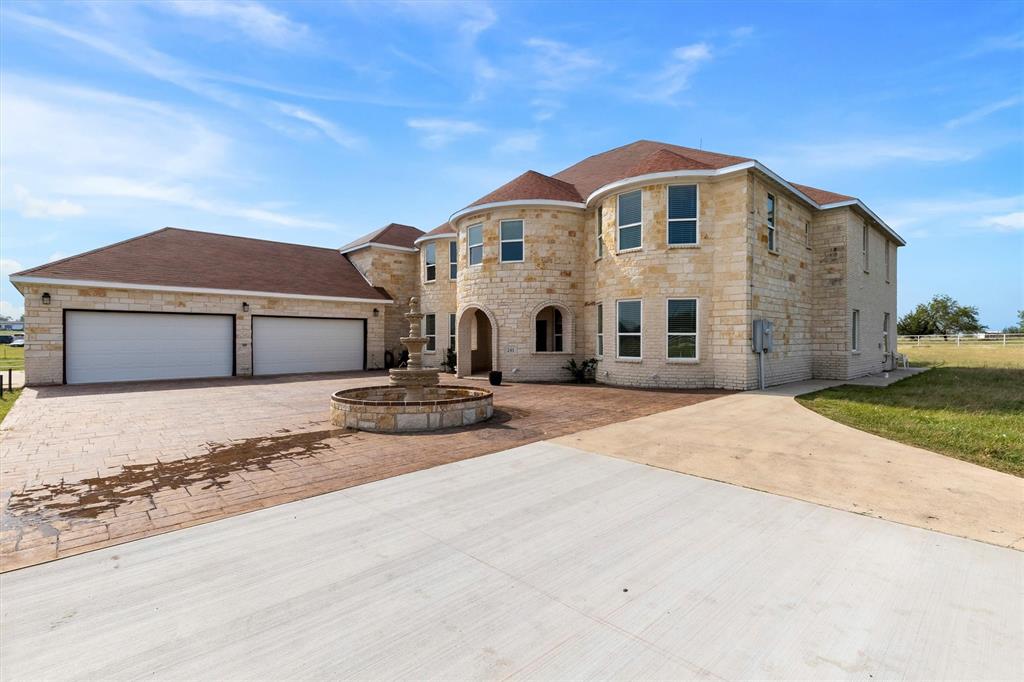 Spacious 7-bedroom Mediterranean-style estate situated on 24.05 ag-exempt acres in Ennis, TX, offering a rare combination of space, privacy, and functionality. Gated entrance leads to a wrap-around driveway with decorative fountain, creating an impressive approach to the home. The residence features stone construction, arched architectural details, and a large open layout with soaring ceilings and abundant natural light. Multiple living areas provide flexibility for large households, entertaining, or multi-generational living. Enjoy outdoor living with a large covered patio and an expansive balcony overlooking the pasture. The land is well-suited for agricultural or recreational use and includes: Two ponds, Mature trees throughout, Barn and additional structures, White pipe fencing along the front portion 8-vehicle covered carport. Conveniently located approximately 3.5 miles from I-45, offering easy access while maintaining a peaceful country setting. Ideal for buyers seeking acreage, livestock use, or a private estate with room to expand. BUYER AND BUYER AGENT TO VERIFY ALL INFORMATION AND MEASUREMENTS!