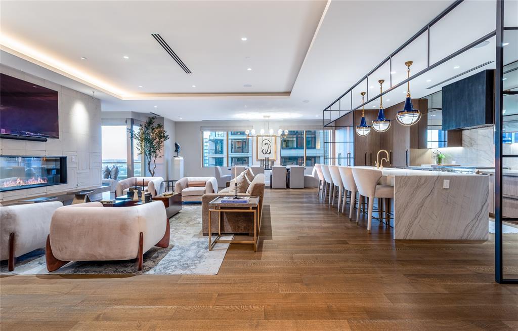 Every detail tells a story of artistry & intention in this bespoke 5,070 sq ft double unit at The Stoneleigh Residences. A masterpiece in the sky where craftsmanship meets couture living. This bespoke residence is a rare one-owner custom home blending timeless design, luxurious materials, & modern sophistication. Every inch is artfully curated with Ornare cabinetry, Aria Quartzite countertops, Ann Sacks tile, Conrad motorized shades, & premier Wolf, Sub-Zero, Meile, and Dacor appliances—including a Scotsman nugget ice maker & in-wall Meile coffee system. A stunning wine wall with built-in Dacor dispenser anchors the open-concept Living-Dining-Kitchen, where a see-through fireplace creates a seamless connection to the Family Room. The private elevator vestibule impresses with inlaid marble floor & double starburst wood doors, while a secondary elevator opens discreetly to the Utility Room for deliveries. A flexible bonus room—perfect for a media, game room, or office—offers leather walls, built-ins, TV & blackout shades with  a huge storage closet. The Primary Suite is an oasis of serenity with hand-painted embroidered wallpaper, dual Ornare closets & dual lavish marble baths featuring a shared oversized double shower. Two spacious balconies, one with a four panel double opening, invite you to savor skyline sunsets or morning coffee with city views & seamlessly invite the outside in. Residents enjoy 5-star amenities including valet, concierge, fitness center, 20-person theater, banquet room with catering kitchen, owners’ lounge, meeting rooms, pool, spa, outdoor fireplaces & grills, a pergola & a treed pet park. Nestled in Uptown, Dallas’ most vibrant corridor near Klyde Warren Park, Victory Park, the #1 Arts District in the U.S., Design District, The Katy Trail, & downtown, this is luxury redefined—elevated, exclusive & exquisitely detailed. Steps away from four hotels & some of Dallas' finest restaurants, shopping & entertainment venues. Convenient to 5 highways.