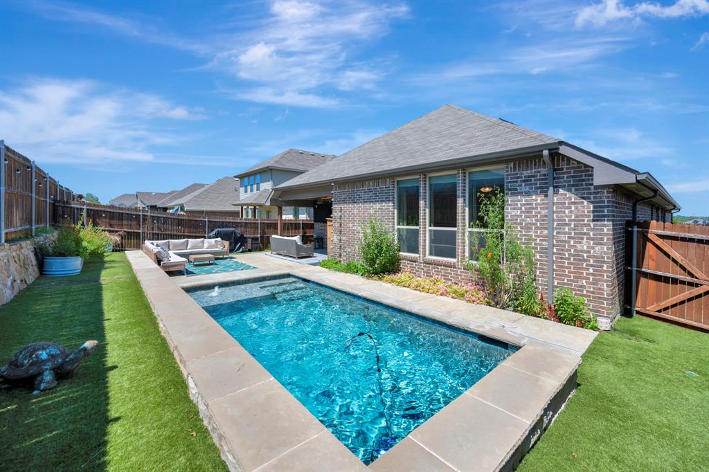 Welcome home to this amazing one story home with a back yard oasis!  Oversized master bathroom with amazing view of your own personal custom, heated swimming pool.  Enjoy the low maintenance back yard and the peaceful sounds of the pool's water features.  With a split bedroom floor plan enjoy privacy in the master suite at the back of the house.  Large open kitchen and a massive island create a welcome area to entertain.  This energy efficient home comes with solar panels(NO LEASE!!!), radiant barrier, low-E windows and insulated doors so you can enjoy low utility bills.  Garage is equipped with a Tesla charger and overhead storage.  With fast and easy access to the major highways this home has it all!